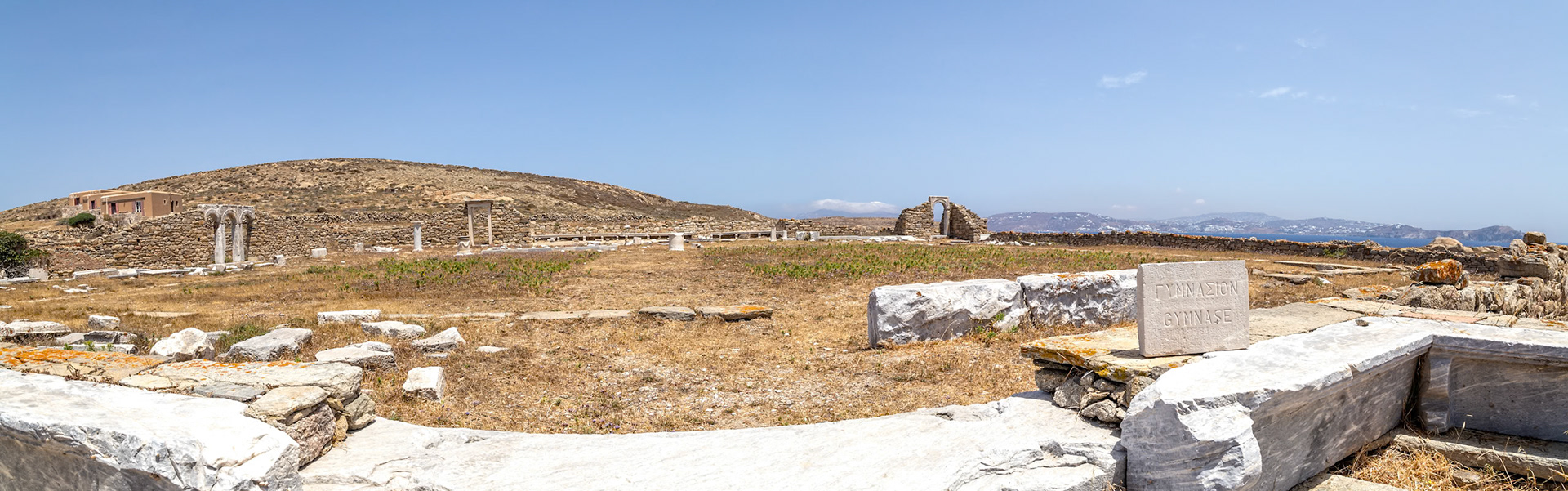 Delos, Greece - May 22nd 2018: Ruins of the Gymnasium, an ancient Greek training facility, stand on Delos, a UNESCO World Heritage Site, showcasing its historical significance.