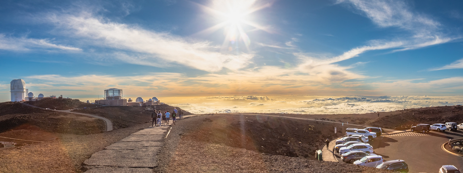 Haleakala, Maui, Hawaii - April 10th 2022: Tourists walk towards the Haleakala Observatory to view the sunrise above the clouds, a popular activity.
