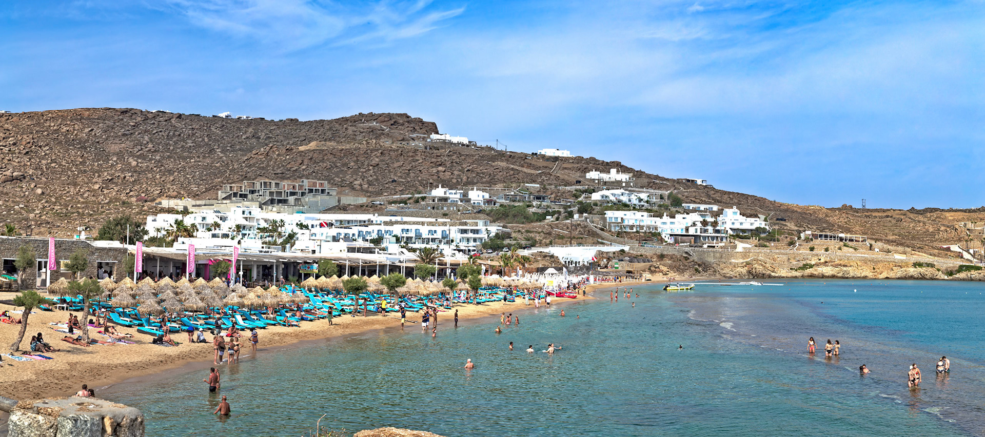 Paradise Beach, Mykonos, Greece - May 24th 2018: Beachgoers enjoy the sun and sea at the popular Paradise Beach, known for its lively atmosphere.