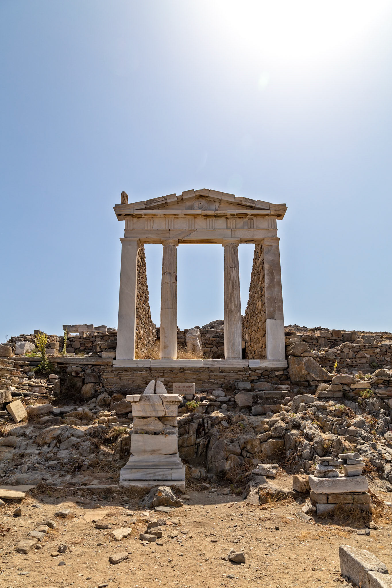 Delos, Greece - May 22nd 2018: Ruins of the Temple of Isis stand against a clear sky. The temple was built in the 2nd century BCE to honor the Egyptian goddess.