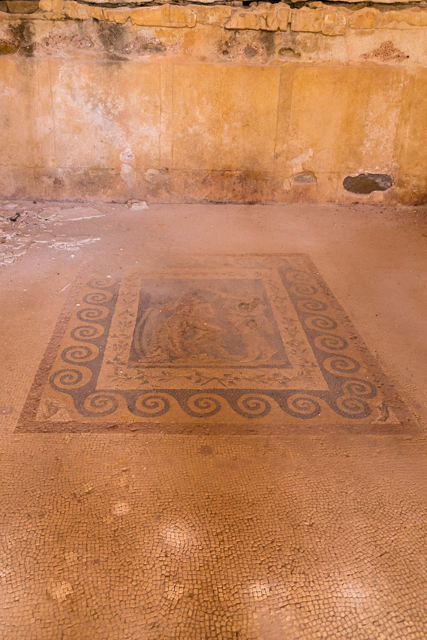 Delos, Greece - May 22nd 2018: An ancient mosaic floor is displayed, showcasing intricate patterns and artistry, preserved to reveal the cultural heritage of Delos.