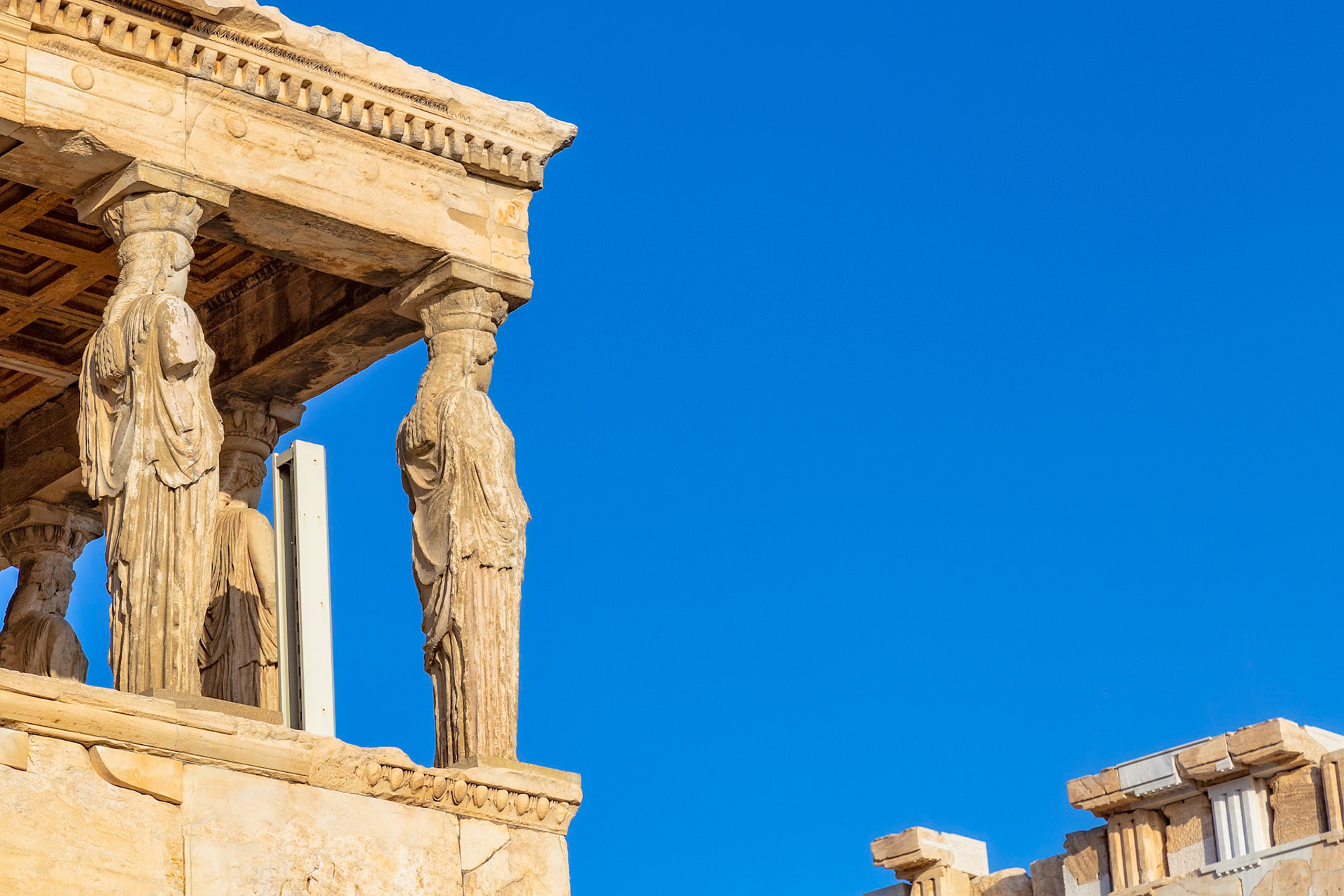 Acropolis, Athens, Greece - May 23rd 2018: The Caryatids, sculpted female figures, support the Erechtheion temple, showcasing ancient Greek architectural artistry.
