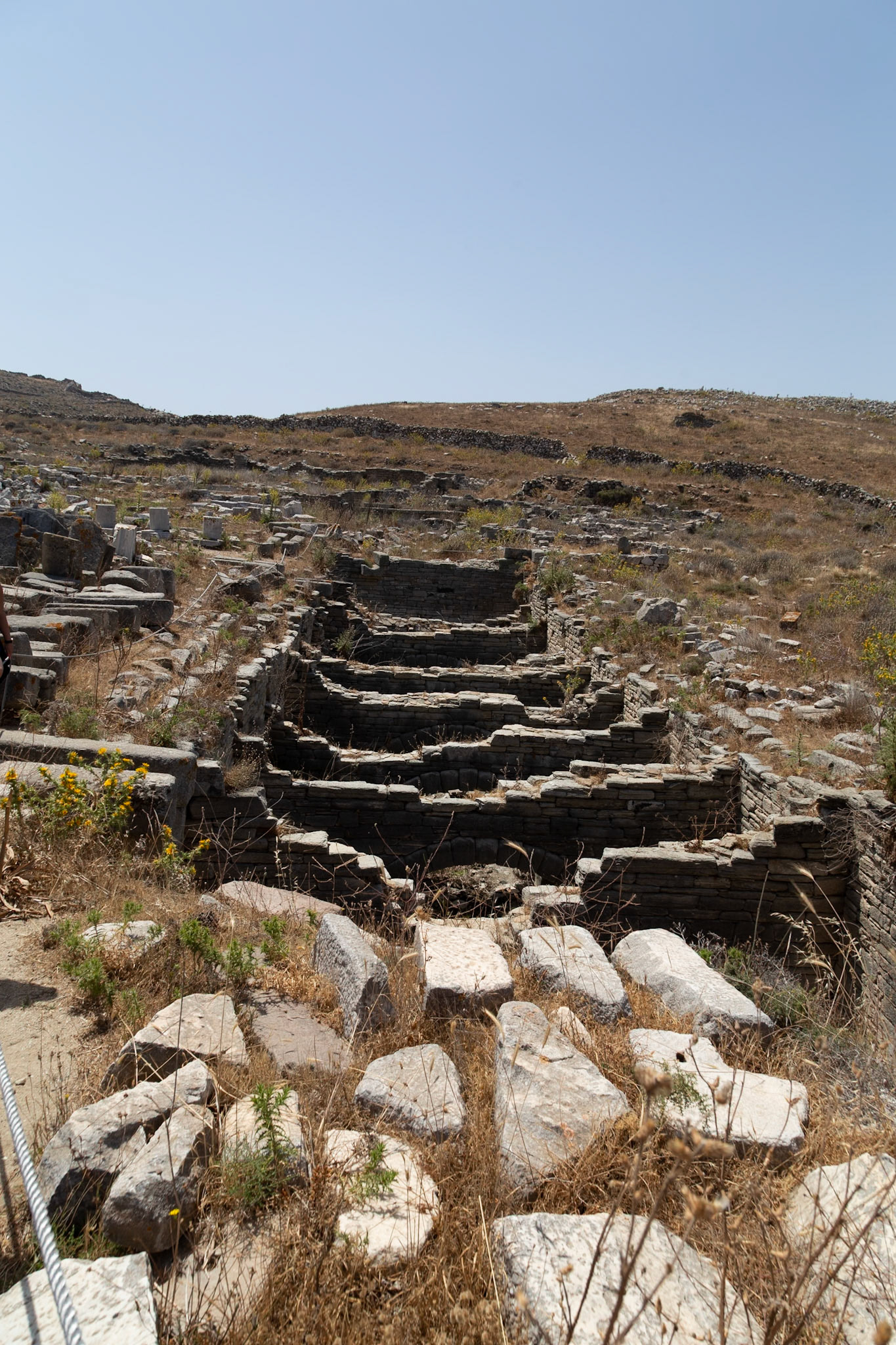 Delos, Greece - May 22nd 2018: Ruins of an ancient structure are seen on the island of Delos, Greece. The ruins are a reminder of the island's rich history.