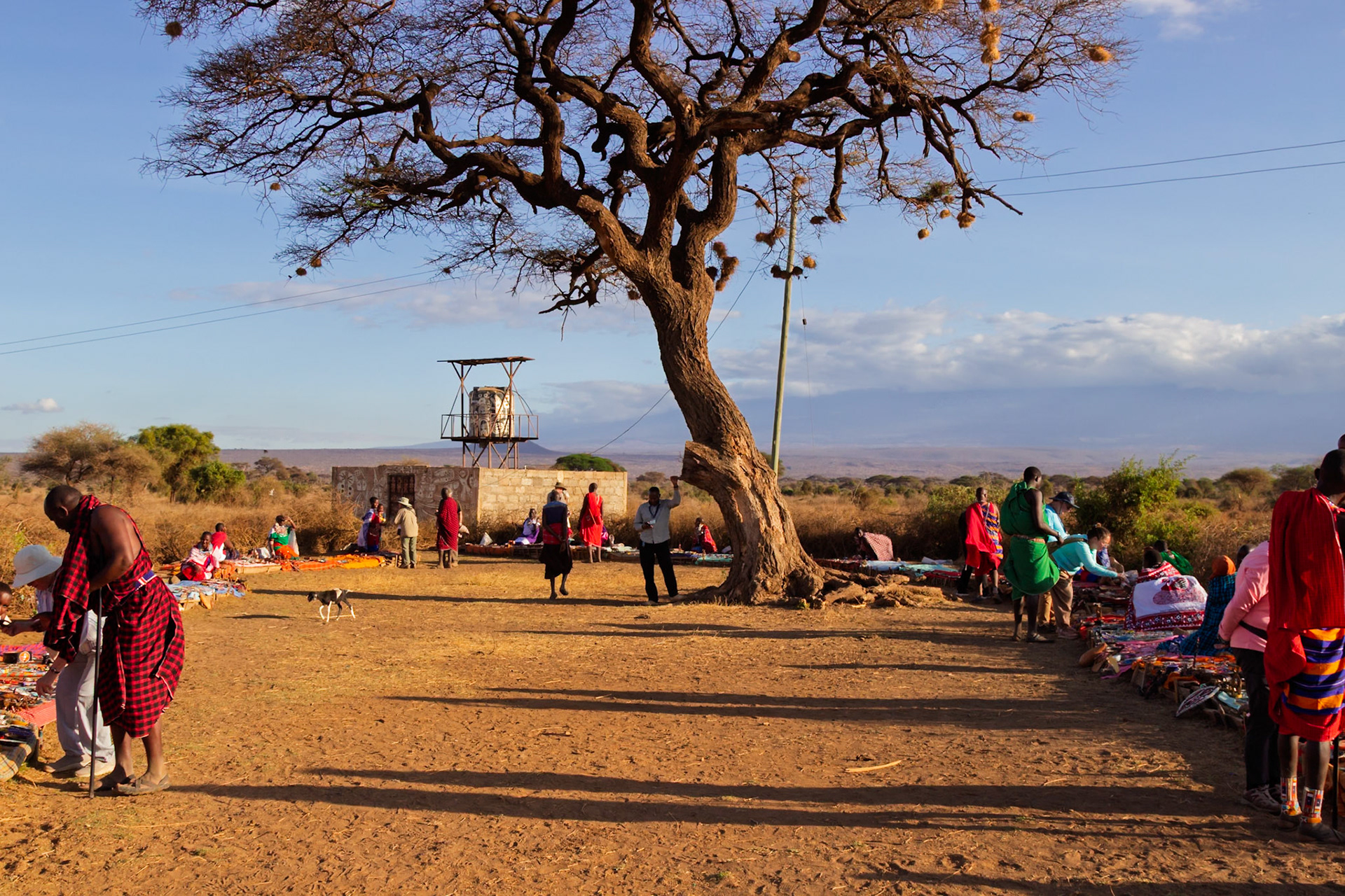 Maasai villagers in Kenya sell crafts to tourists, boosting their economy and sharing their culture.