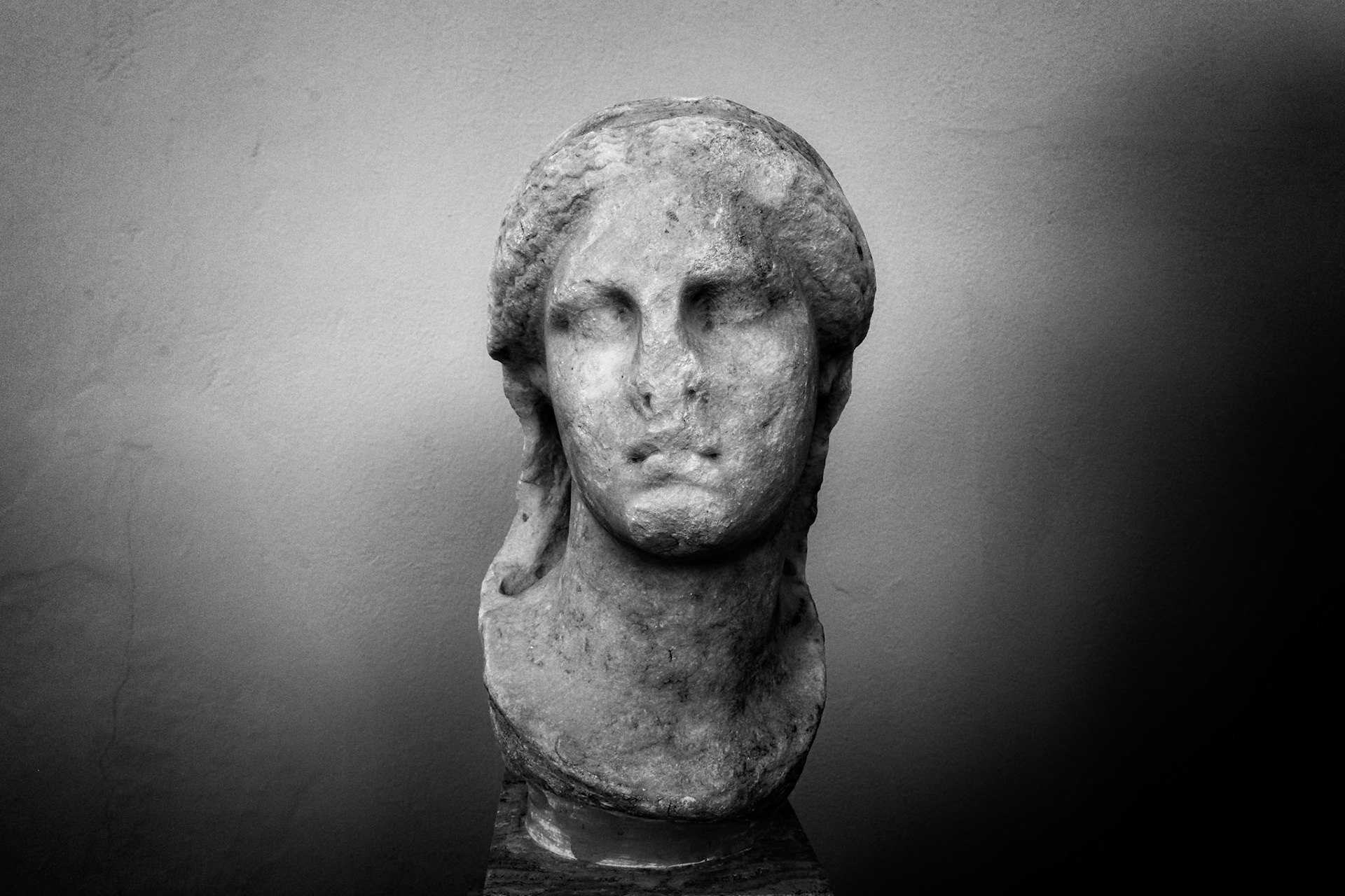 Delos, Greece - May 22nd 2018: A weathered marble bust of a woman stands as a testament to ancient artistry, inviting contemplation on history and beauty.