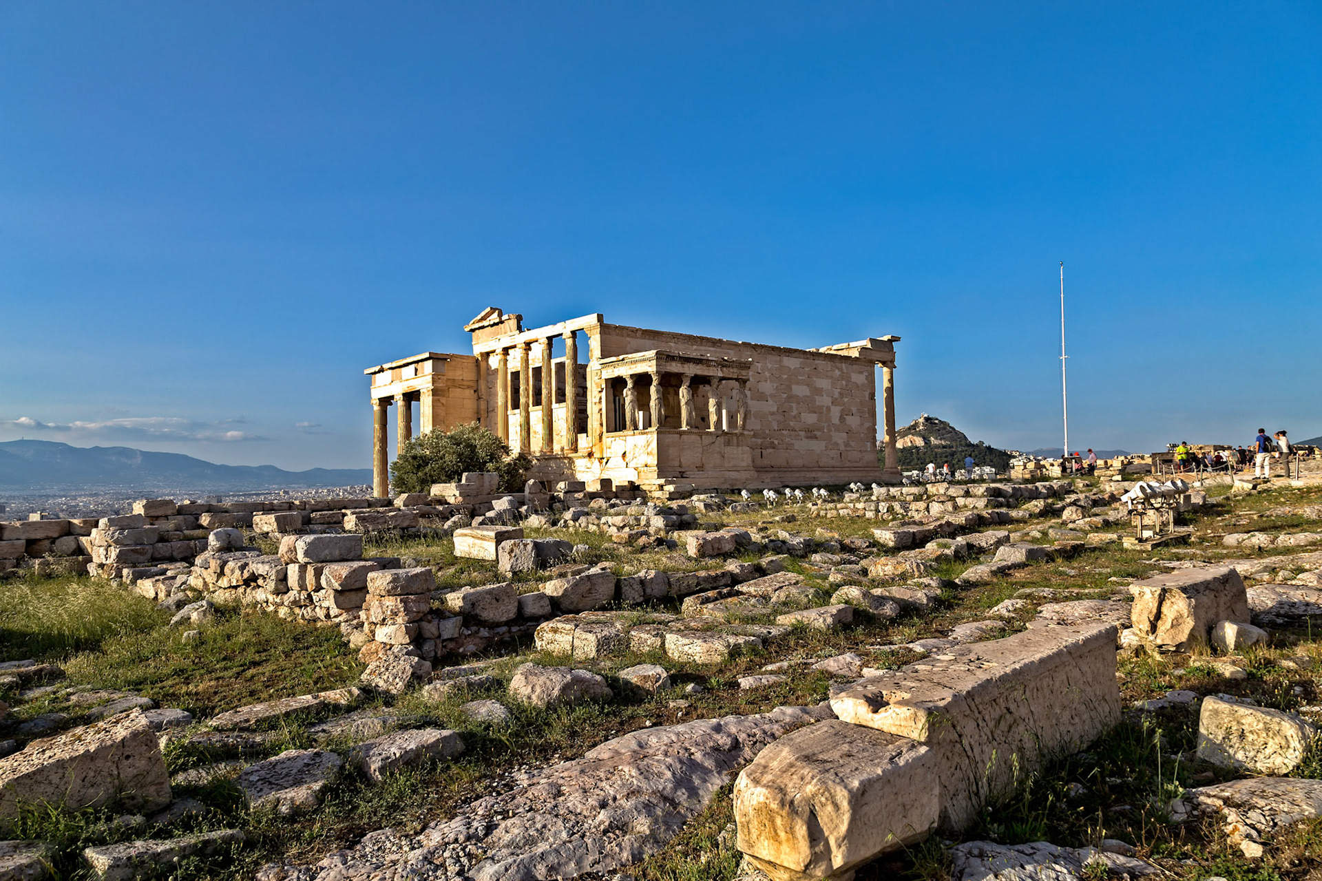 Acropolis, Athens, Greece - May 23rd 2018: Tourists visit the Erechtheion, an ancient Greek temple on the north side of the Acropolis, to learn about its history.