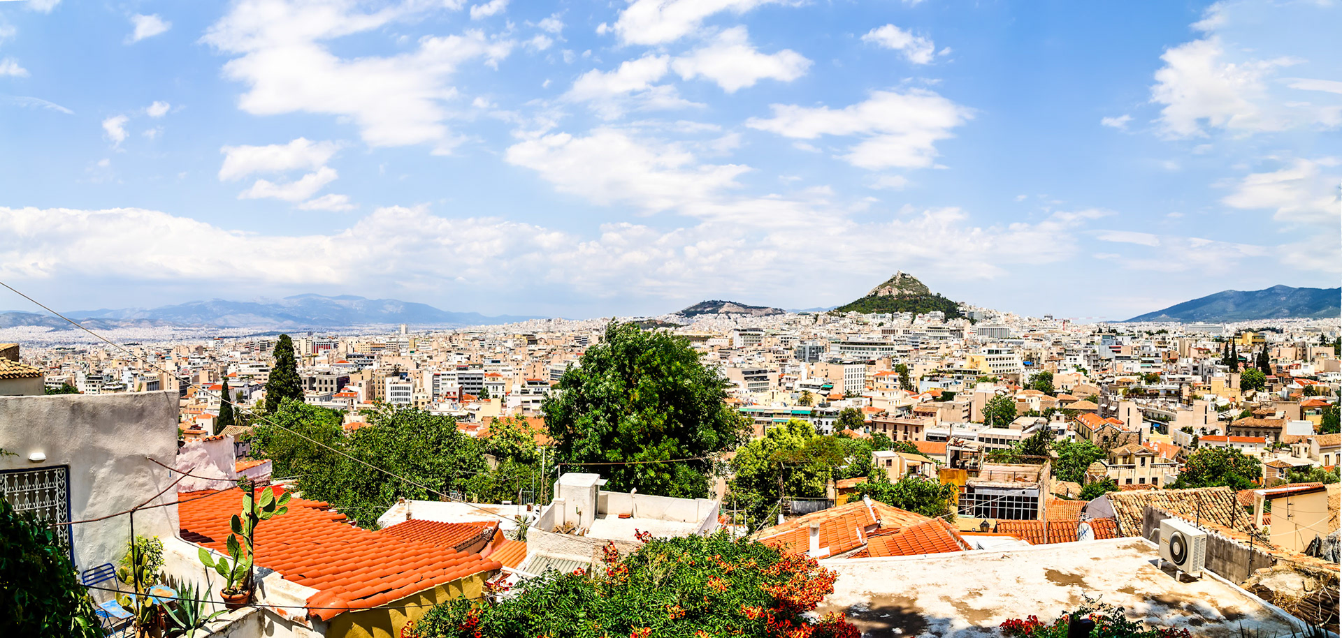 Athens, Greece - May 23rd 2018: A panoramic view of Athens shows the city's urban sprawl, with Mount Lycabettus prominently visible in the background.