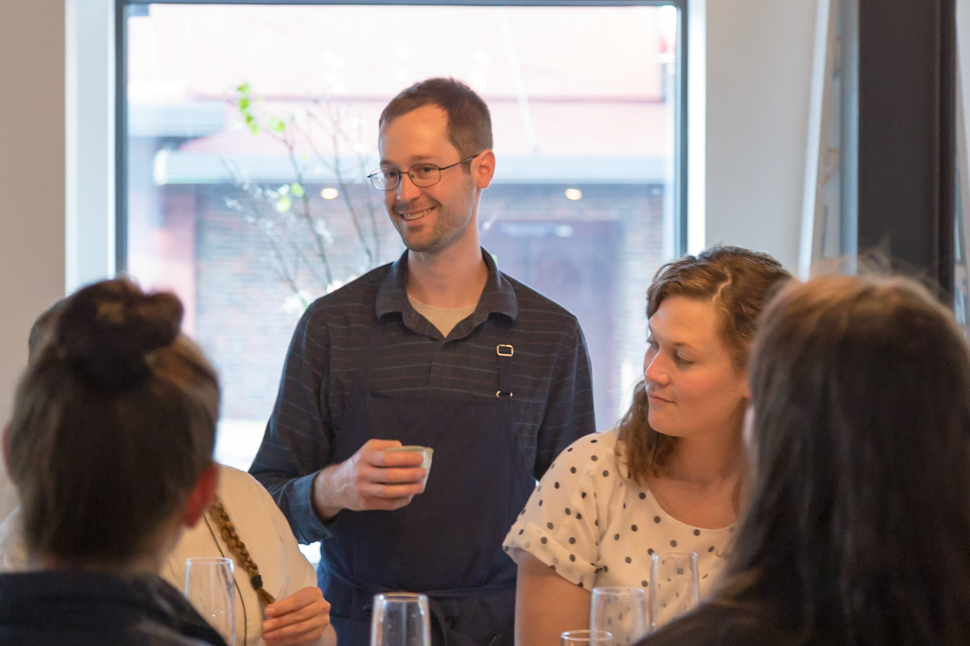 Fog Lark, Portland, Oregon - April 6th 2018: A chef presents a dish to a group of diners, explaining the ingredients and preparation.