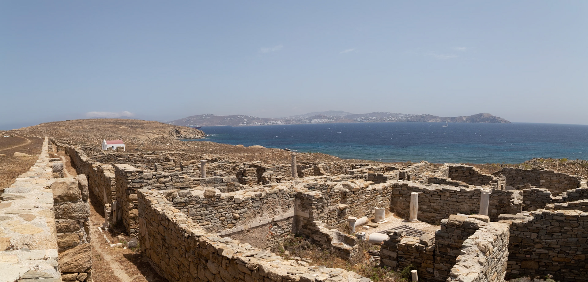 Delos, Greece - May 22nd 2018: Ruins of ancient buildings stand on Delos, a Greek island and archaeological site, offering a glimpse into its rich history and culture.