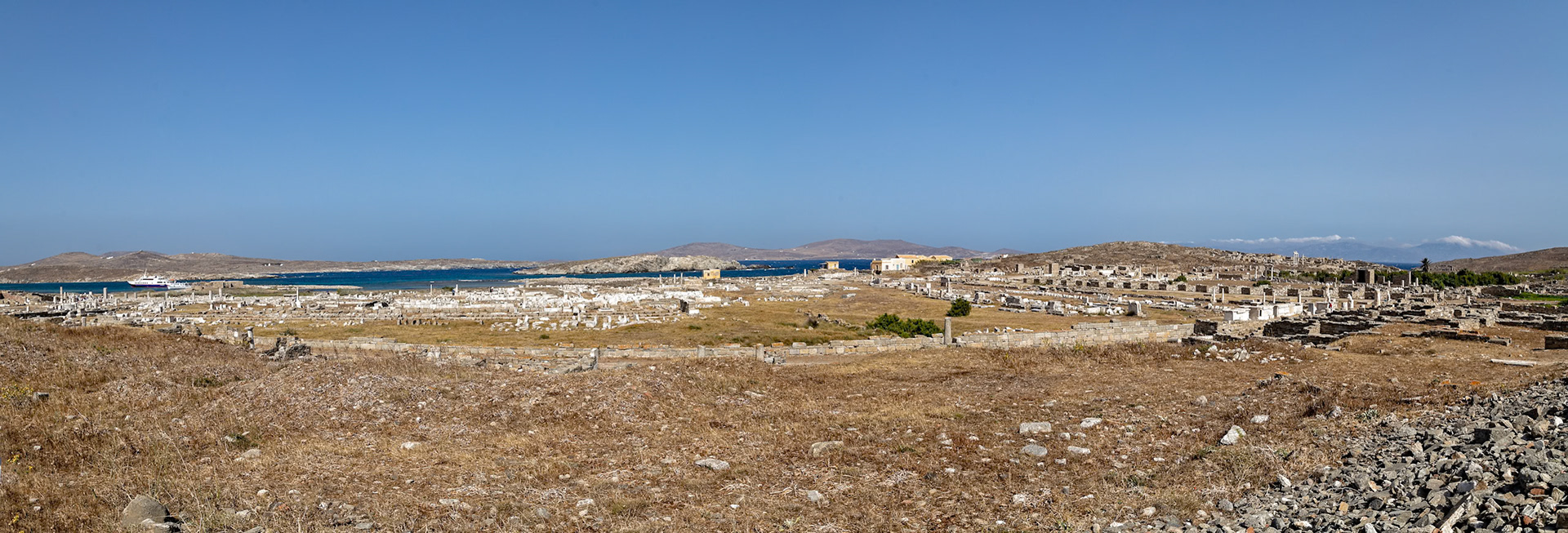 Delos, Greece - May 22nd 2018: Ruins of the ancient city of Delos, a UNESCO World Heritage site, are preserved for visitors to explore and learn about Greek history.