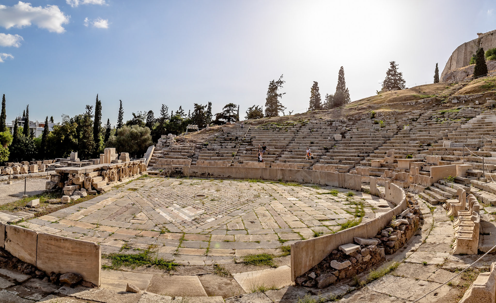 Acropolis, Athens, Greece - May 23rd 2018: Tourists explore the ancient Theatre of Dionysus, a major open-air theatre and important landmark.