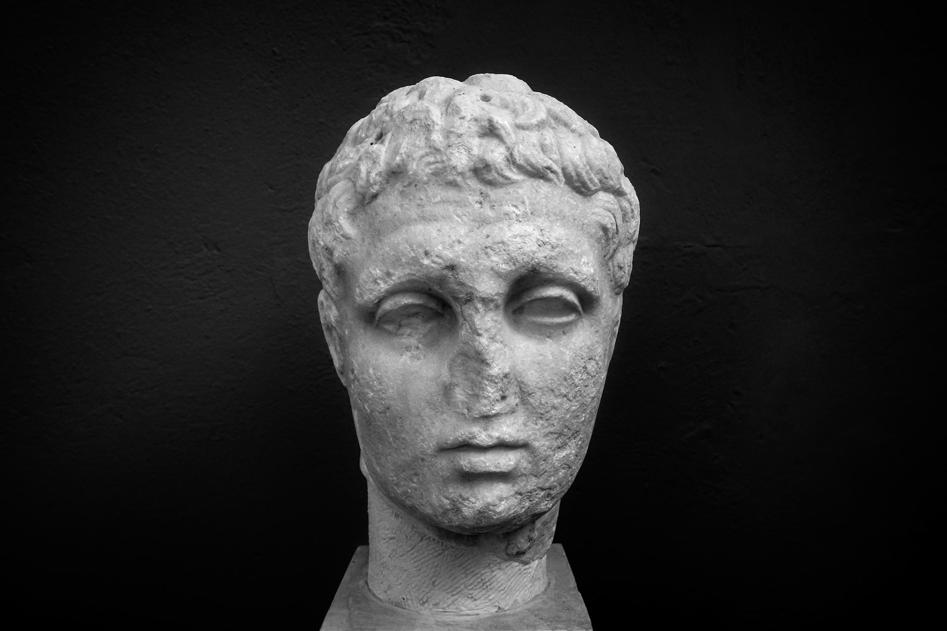 Delos, Greece - May 22nd 2018: A marble head of a young man, possibly a portrait of a local dignitary, is on display at the Delos Archaeological Museum.