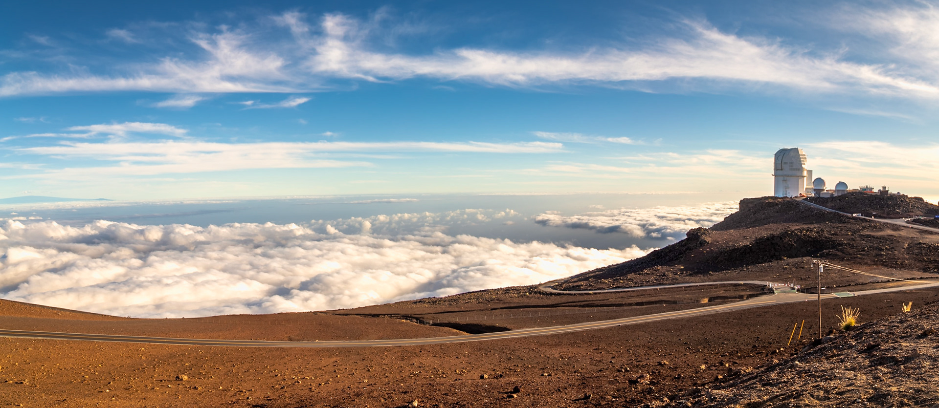 Haleakala, Maui, Hawaii - April 10th 2022: A panoramic view of the Haleakala Observatory, a research facility used for astronomical observations above the clouds.