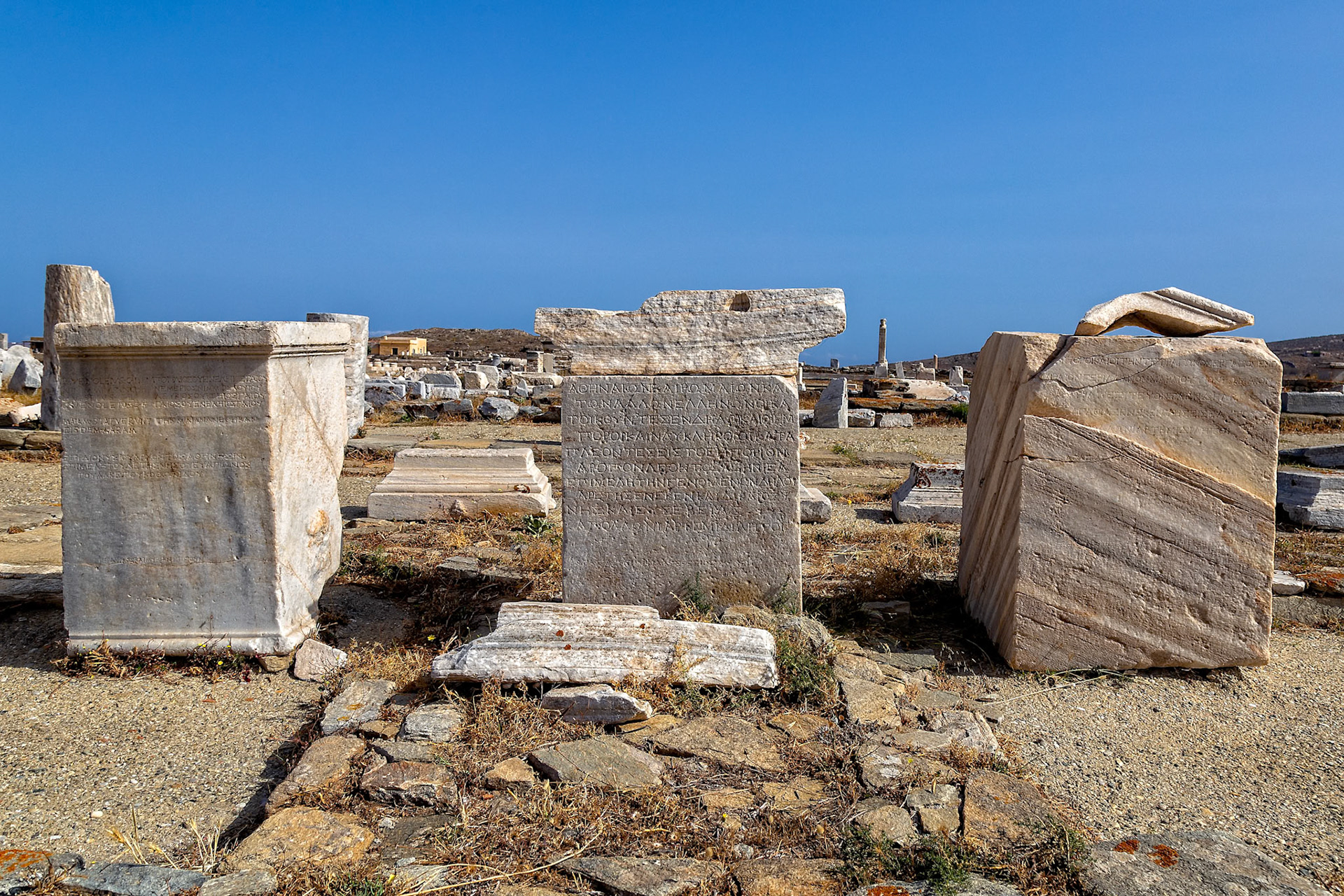 Delos, Greece - May 22nd 2018: Ancient Greek inscriptions on marble blocks at Delos, a UNESCO World Heritage Site. The inscriptions provide insights into the island's history.