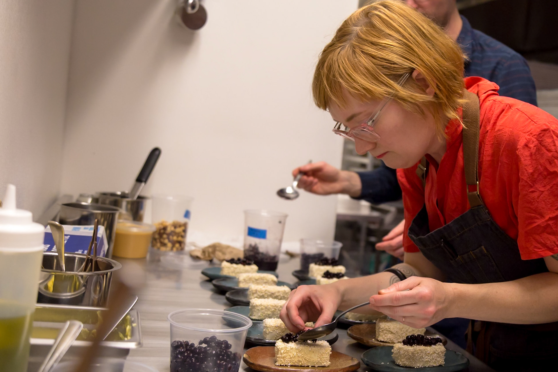 Fog Lark, Portland, Oregon - April 6th 2018: A chef carefully plates desserts with blueberries, ensuring each is perfect for service.