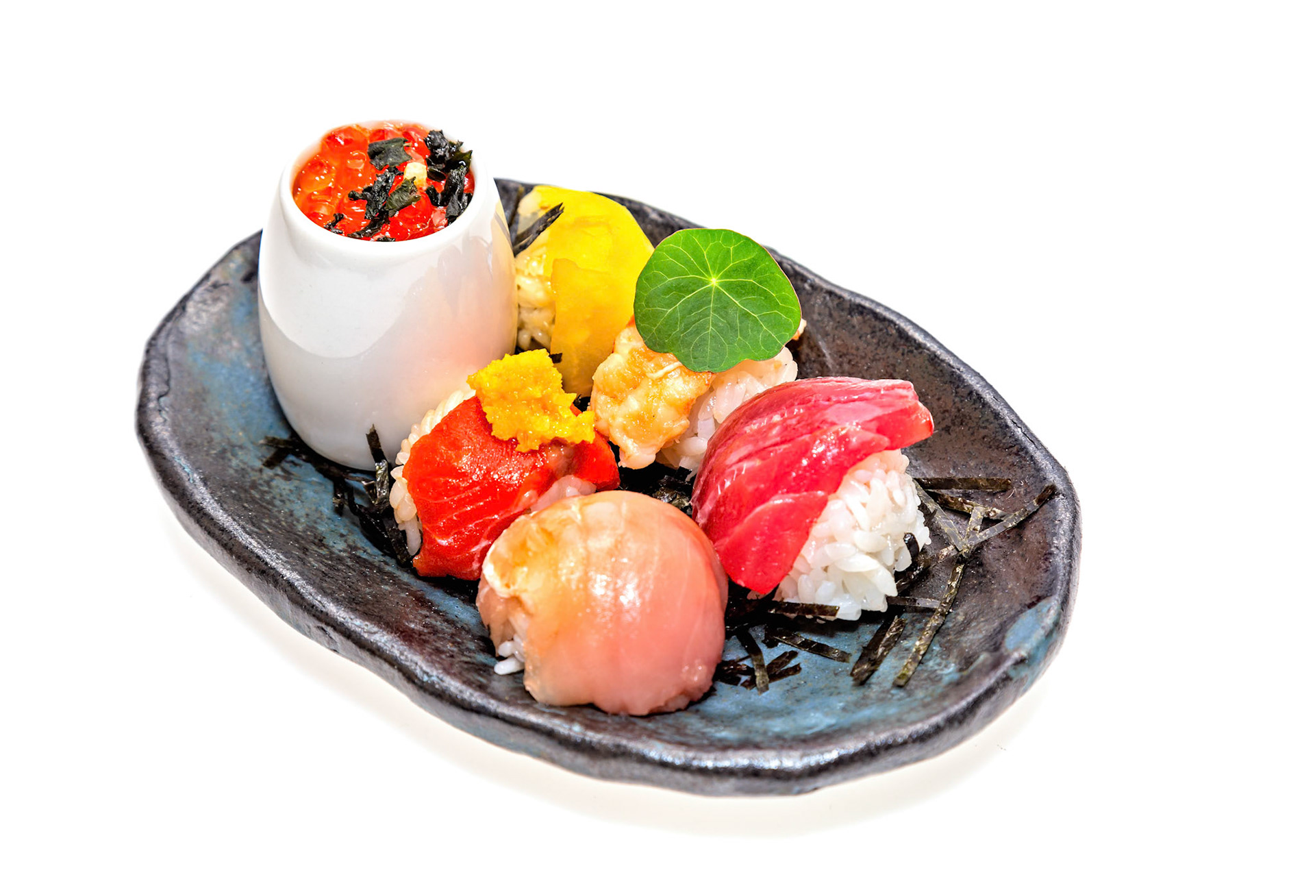 Fog Lark, Portland, Oregon - March 15th 2019: A plate of assorted sushi, including salmon roe, tuna, and yellowtail, is presented for a culinary experience.