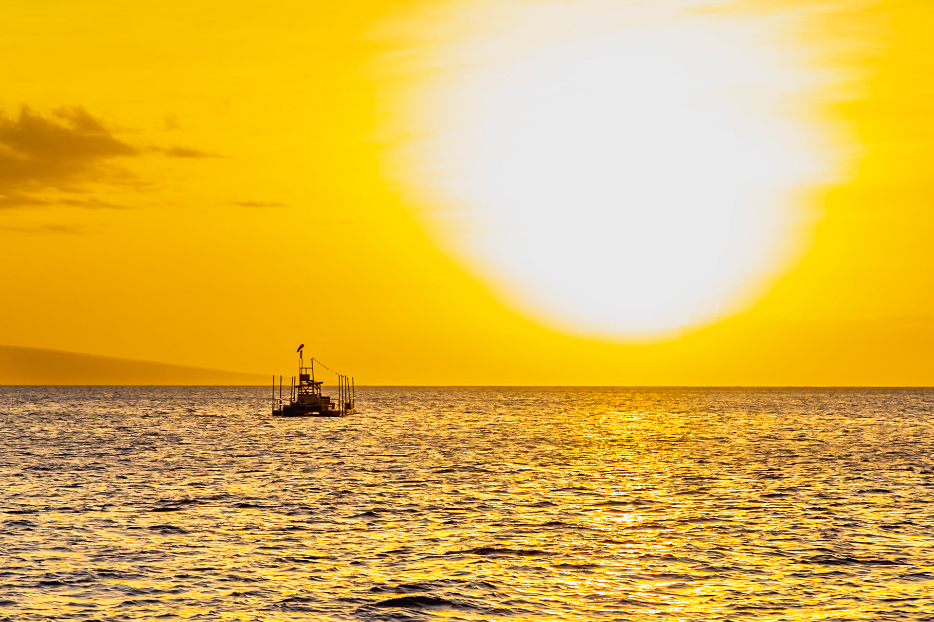 Maui, Hawaii, USA - April 7th 2022: A research platform sits in the ocean at sunset, possibly for marine studies or environmental monitoring.