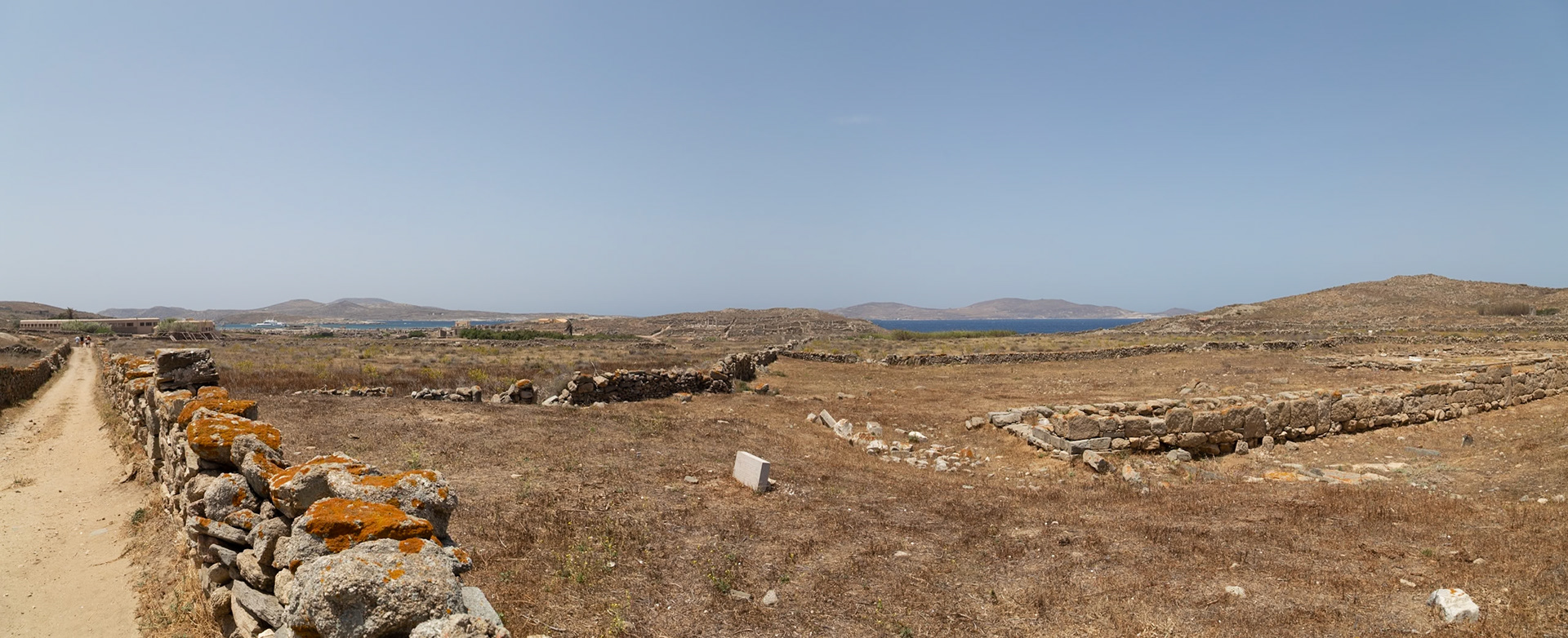 Delos, Greece - May 22nd 2018: Ruins of ancient structures stand on Delos, a Greek island and archaeological site, showcasing its historical significance.