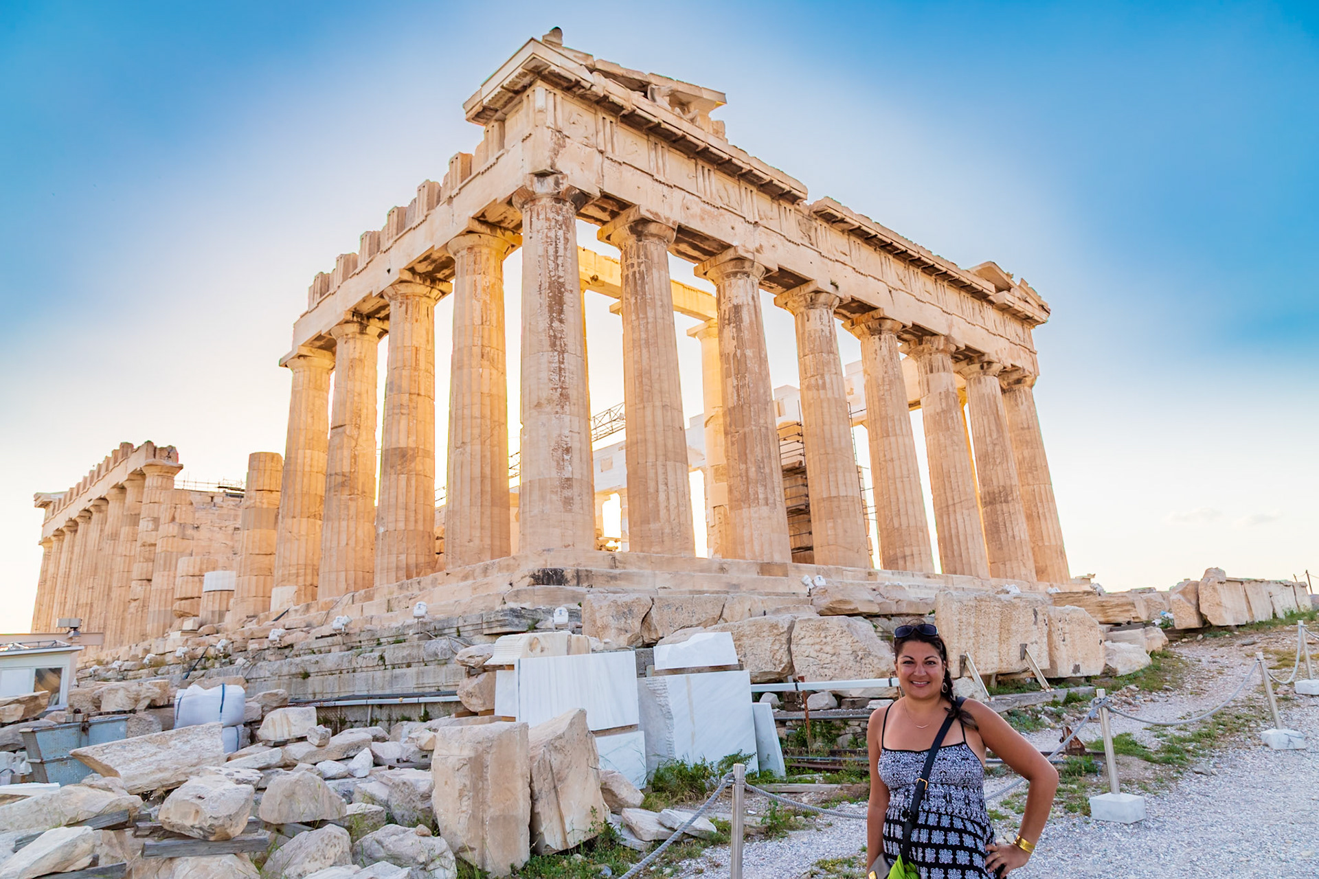 Acropolis, Athens, Greece - May 23rd 2018: A tourist poses in front of the Parthenon, a former temple, now a popular tourist attraction.