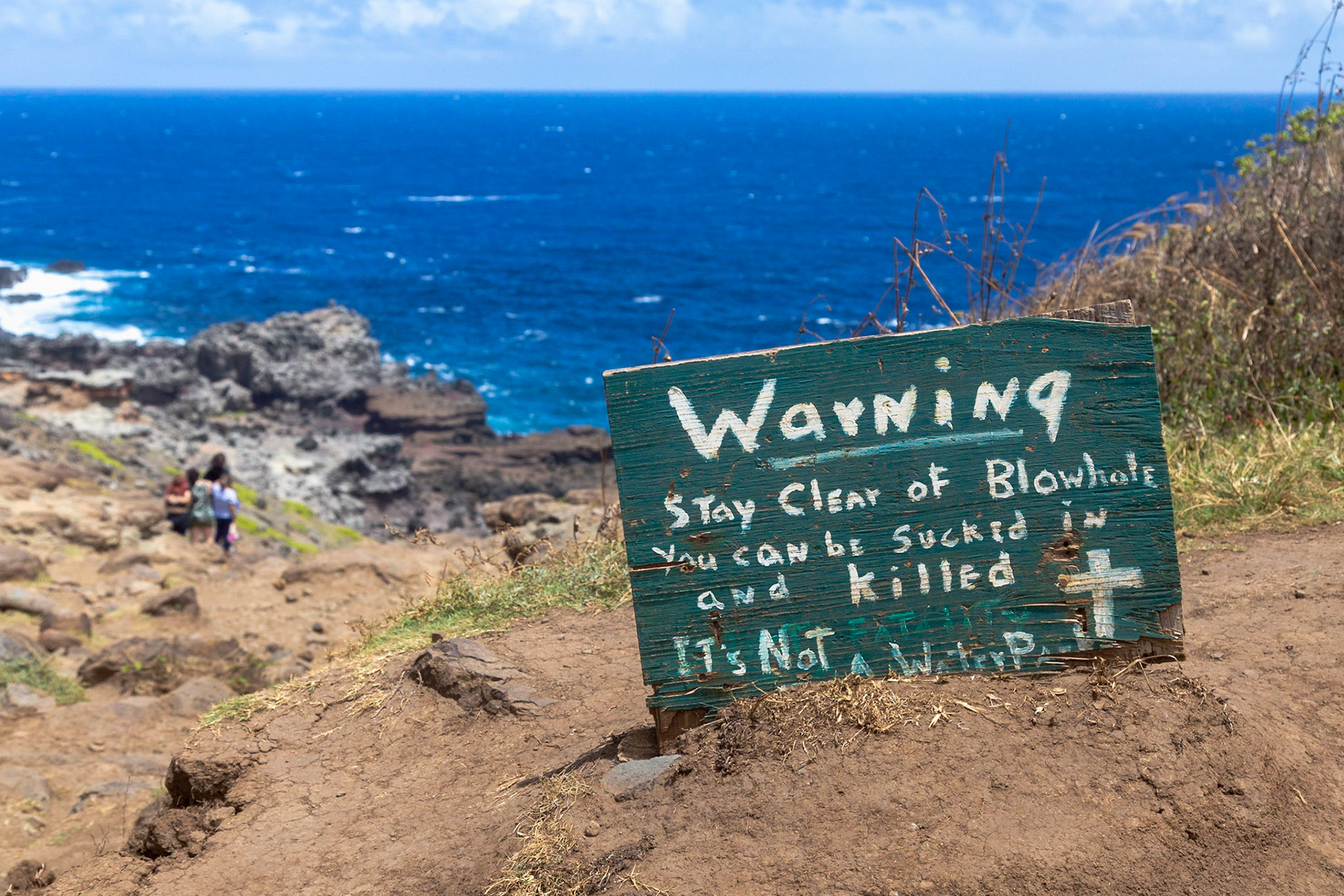 Maui, Hawaii, USA - April 9th 2022: A warning sign advises hikers to stay clear of the blowhole, as it's not a water park, for safety.