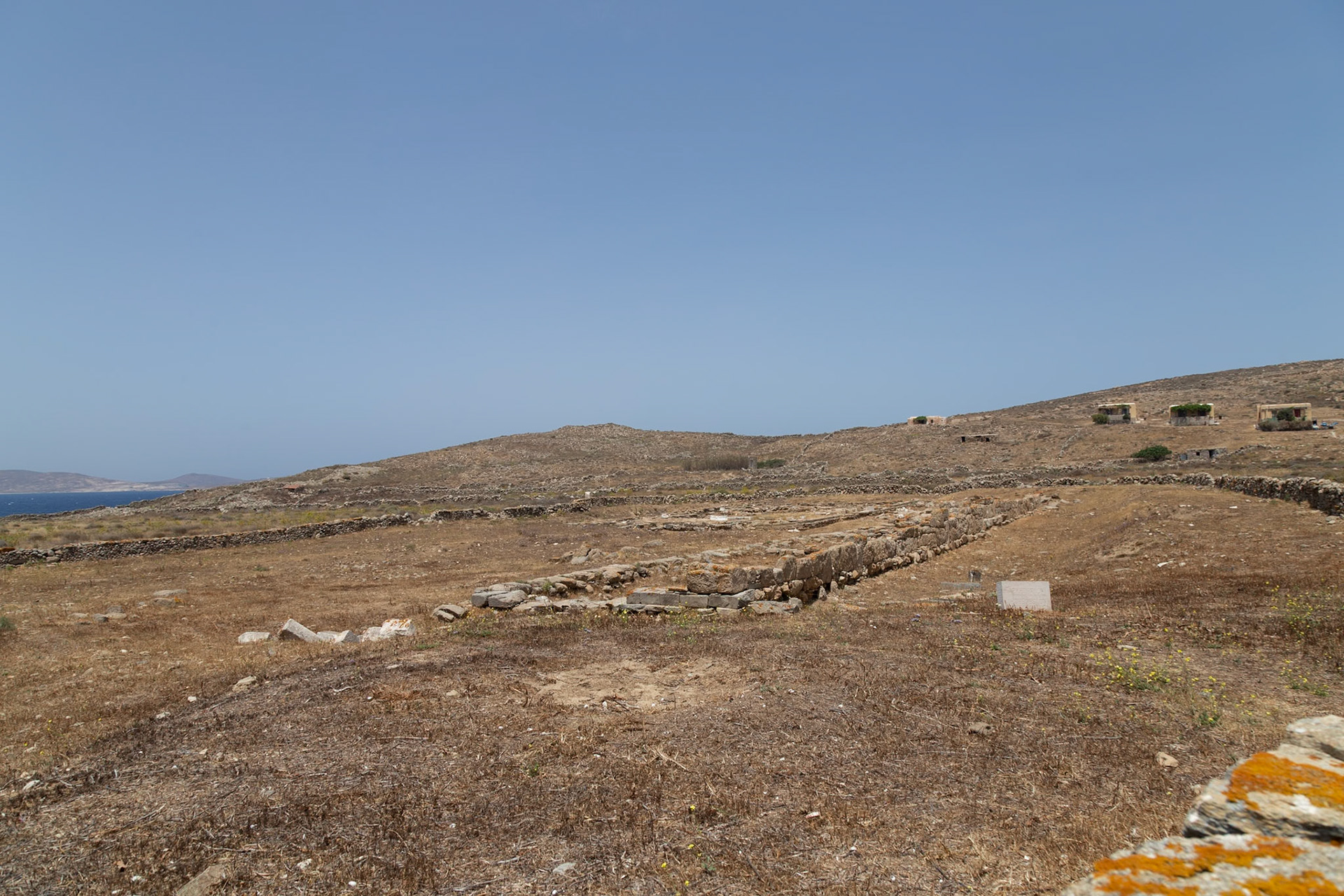 Delos, Greece - May 22nd 2018: Ruins of ancient structures stand on the island of Delos, a UNESCO World Heritage site, showcasing its rich history and archaeological significance.