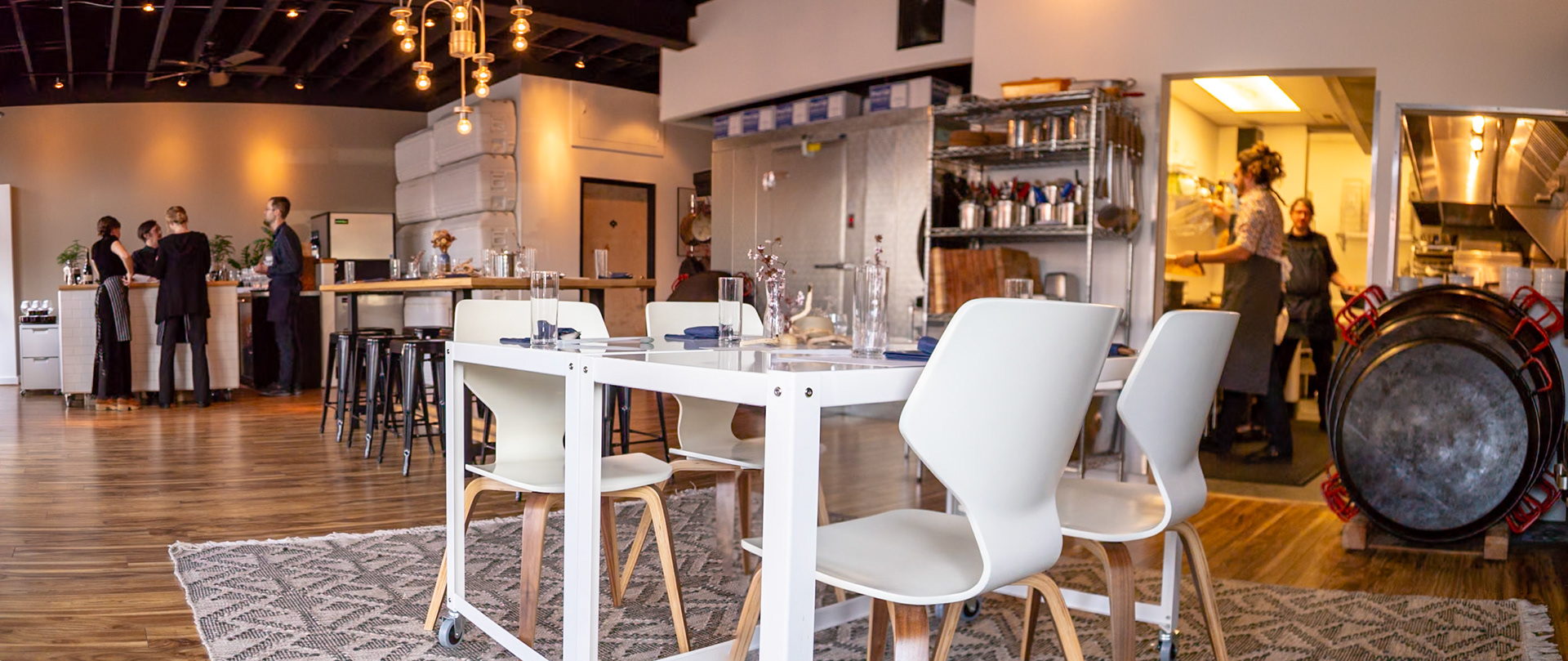 Fog Lark, Portland, Oregon - April 6th 2018: Staff prepares for service at Fog Lark, setting tables and prepping in the kitchen for the evening.