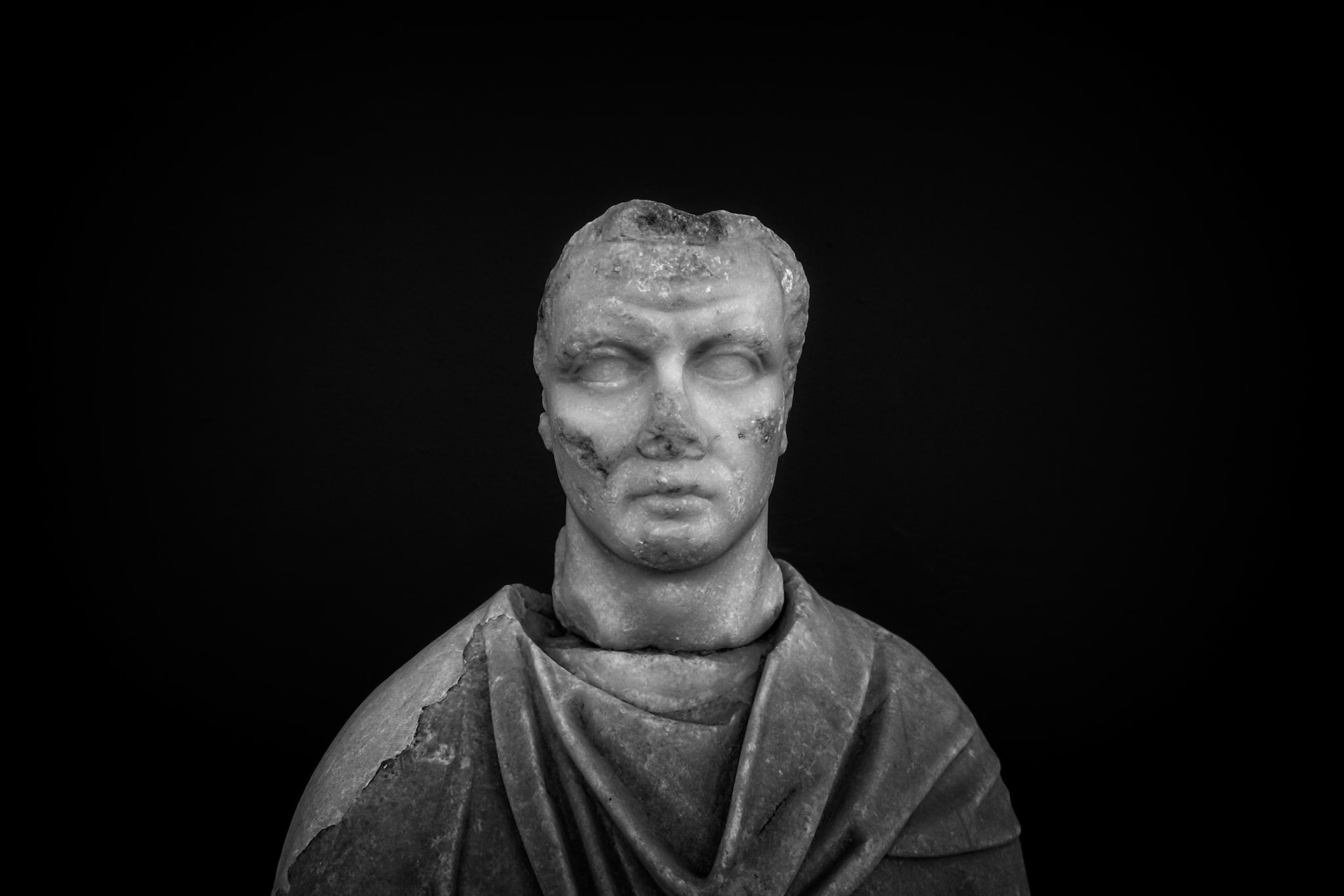 Delos, Greece - May 22nd 2018: A marble bust of a man, possibly a Roman official, stands as a testament to the island's rich history and cultural significance.