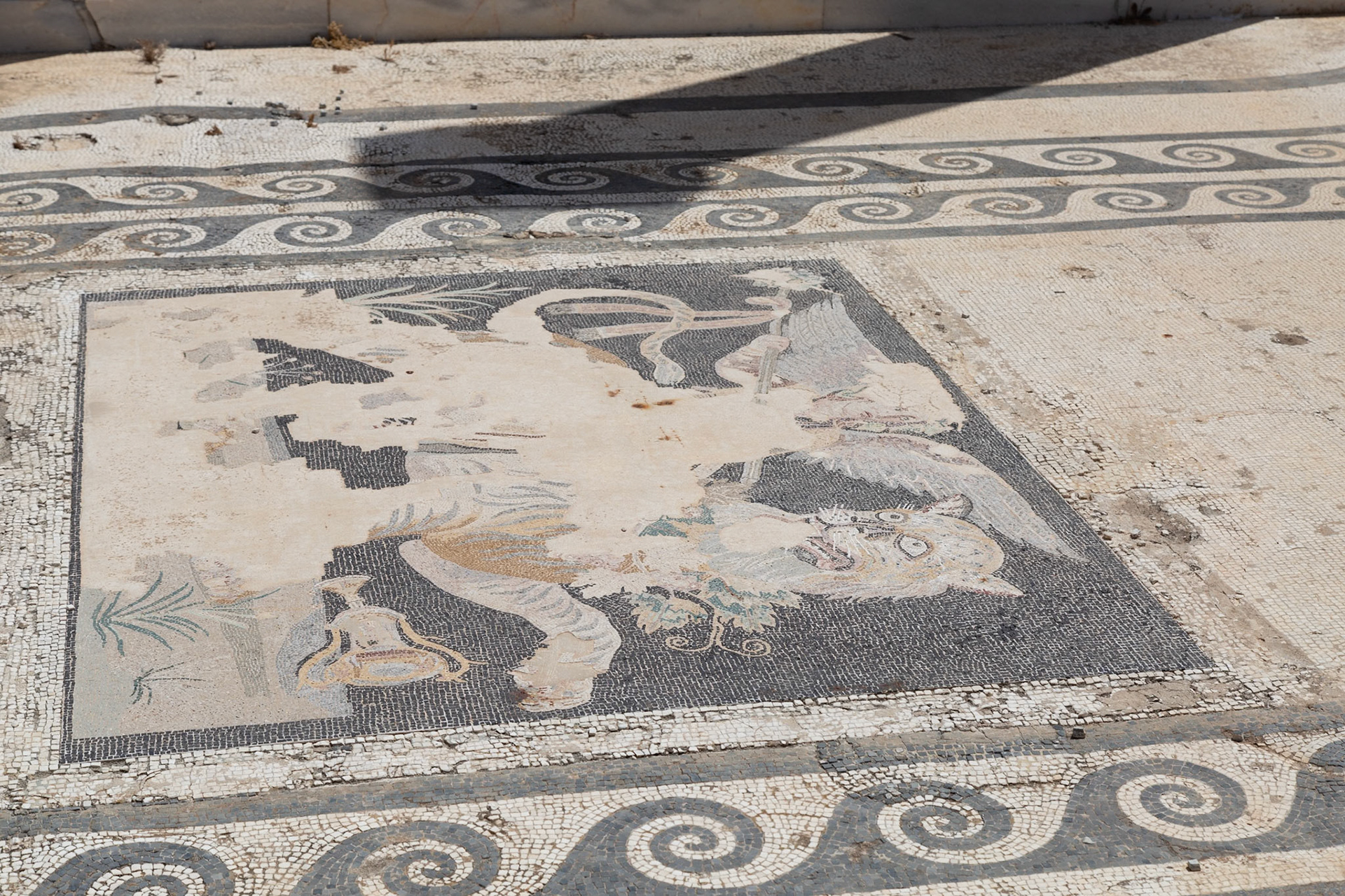 Delos, Greece - May 22nd 2018: A mosaic floor depicts Dionysus riding a panther, a common theme in ancient Greek art, symbolizing the god's power and connection to nature.