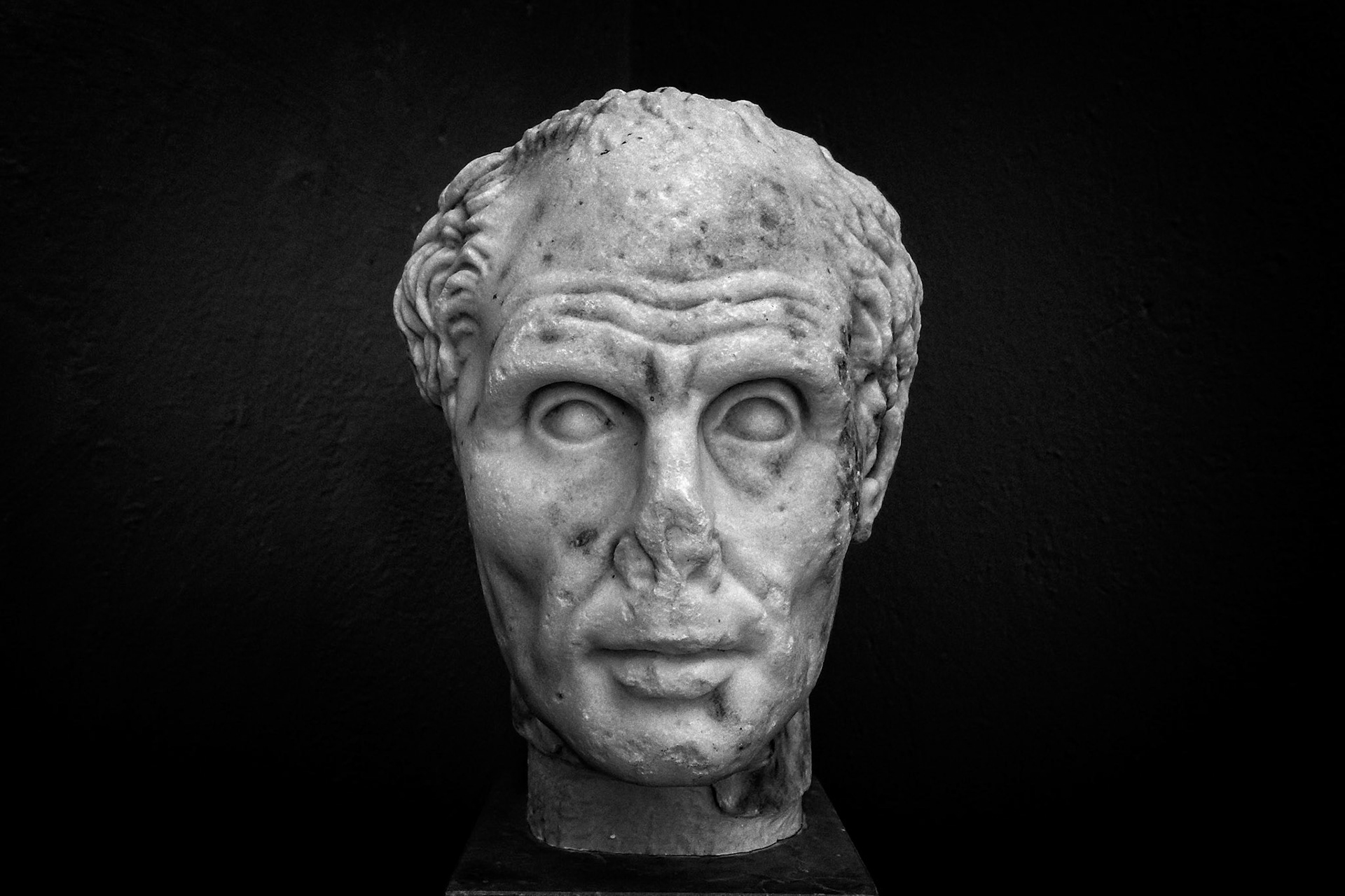 Delos, Greece - May 22nd 2018: A marble head of a man, possibly a Roman official, is displayed. It's an artifact showcasing ancient artistry and historical significance.