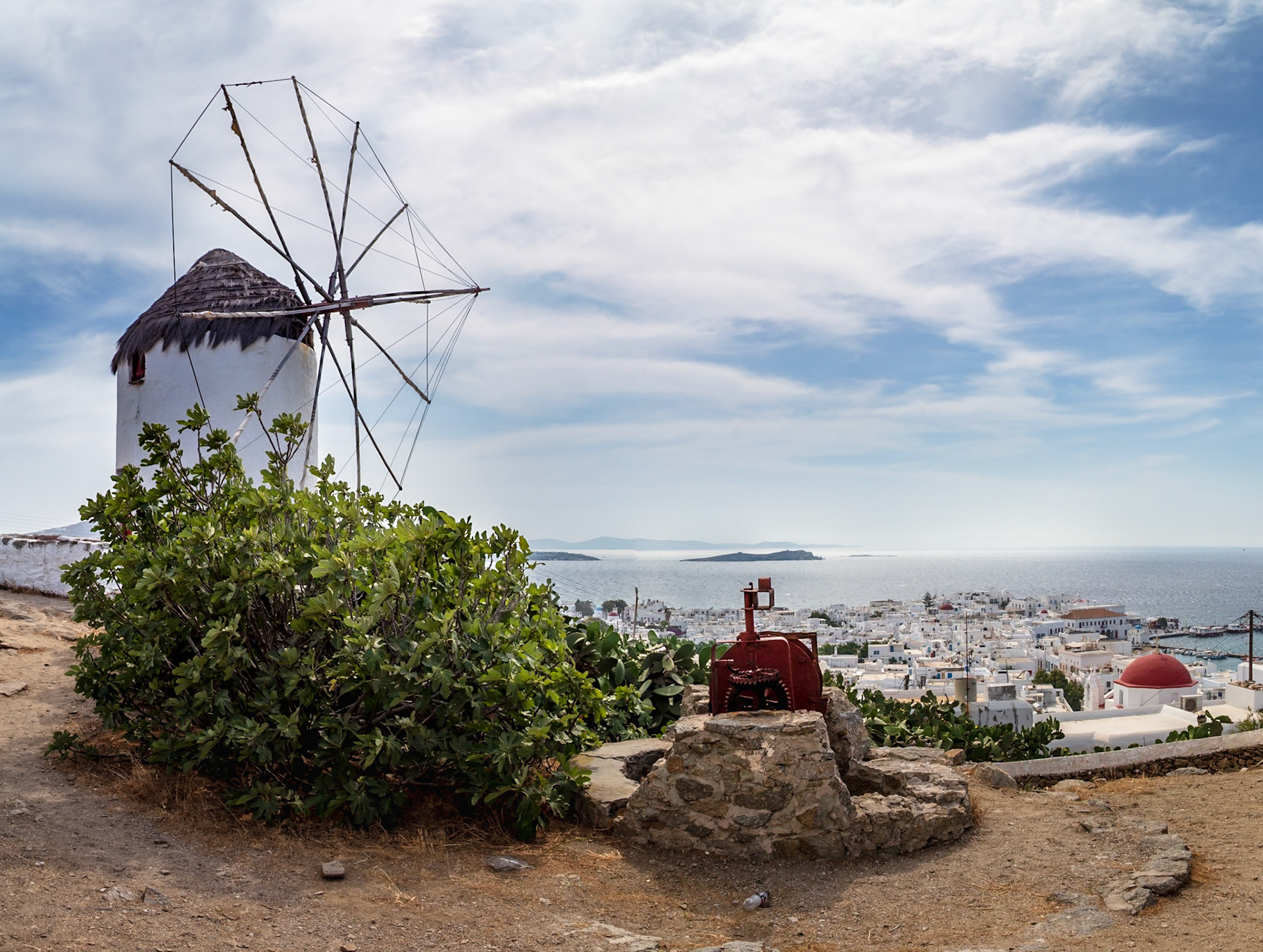 Mykonos, Greece - May 22nd 2018: A windmill stands overlooking the town, a reminder of the island's history and agricultural past.