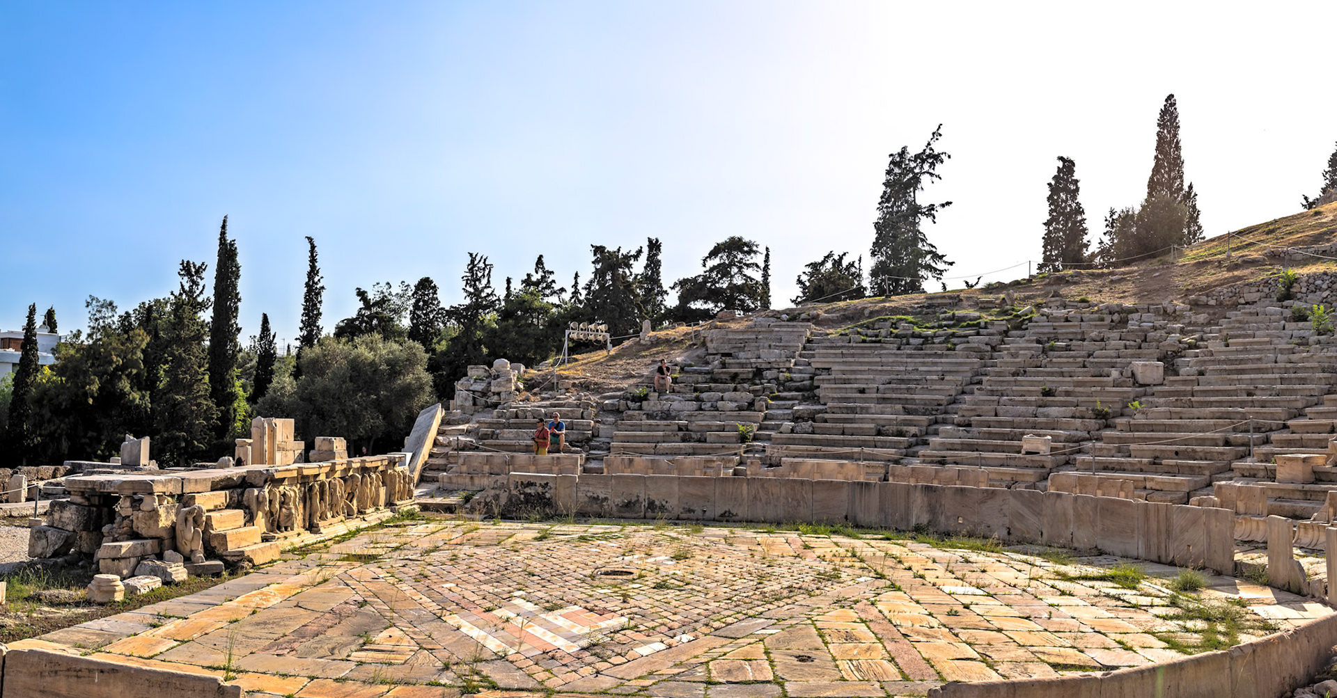 Acropolis, Athens, Greece - May 23rd 2018: Tourists explore the ancient Theatre of Dionysus, a major open-air theatre and important historical site.
