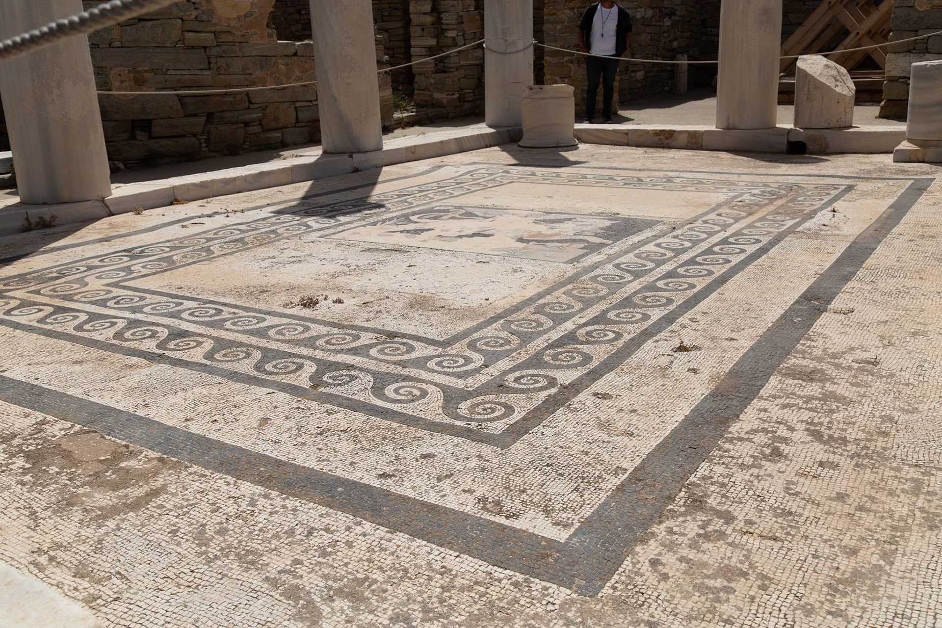 Delos, Greece - May 22nd 2018: A mosaic floor is displayed, showcasing intricate patterns and designs, preserved as part of the island's rich archaeological heritage.