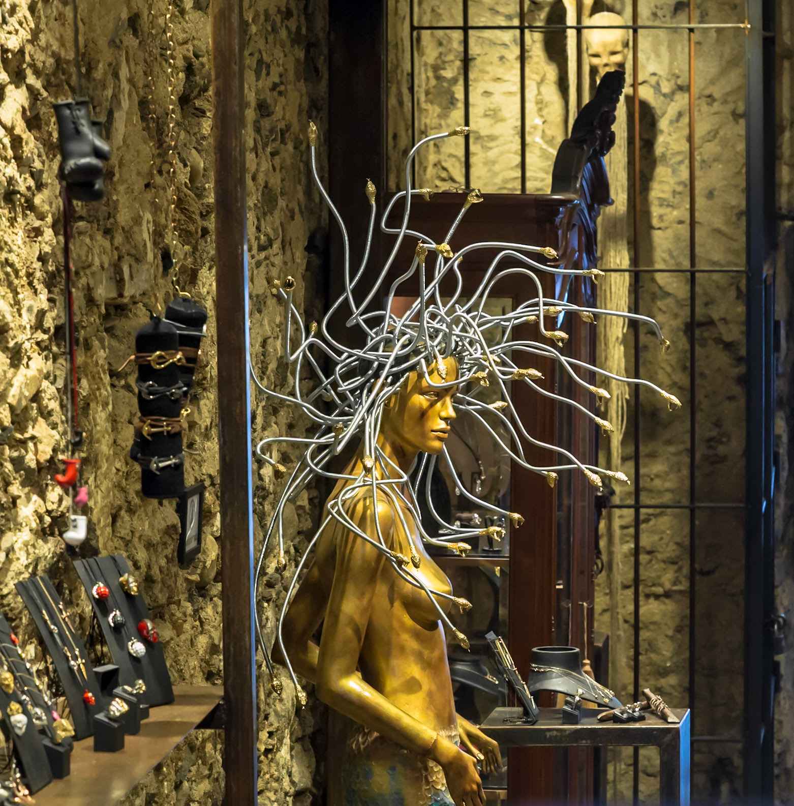 Mykonos, Greece - May 23rd 2018: A Medusa mannequin is displayed in a shop window, showcasing jewelry and other items for sale to tourists.