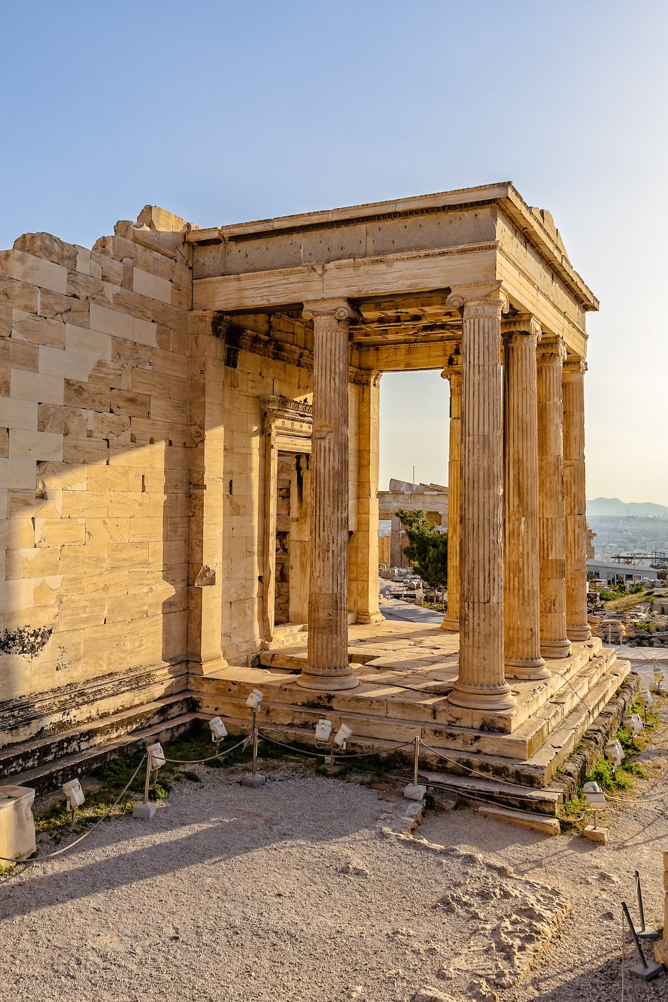 Acropolis, Athens, Greece - May 23rd 2018: The Erechtheion, an ancient Greek temple on the north side of the Acropolis, is viewed at sunset.