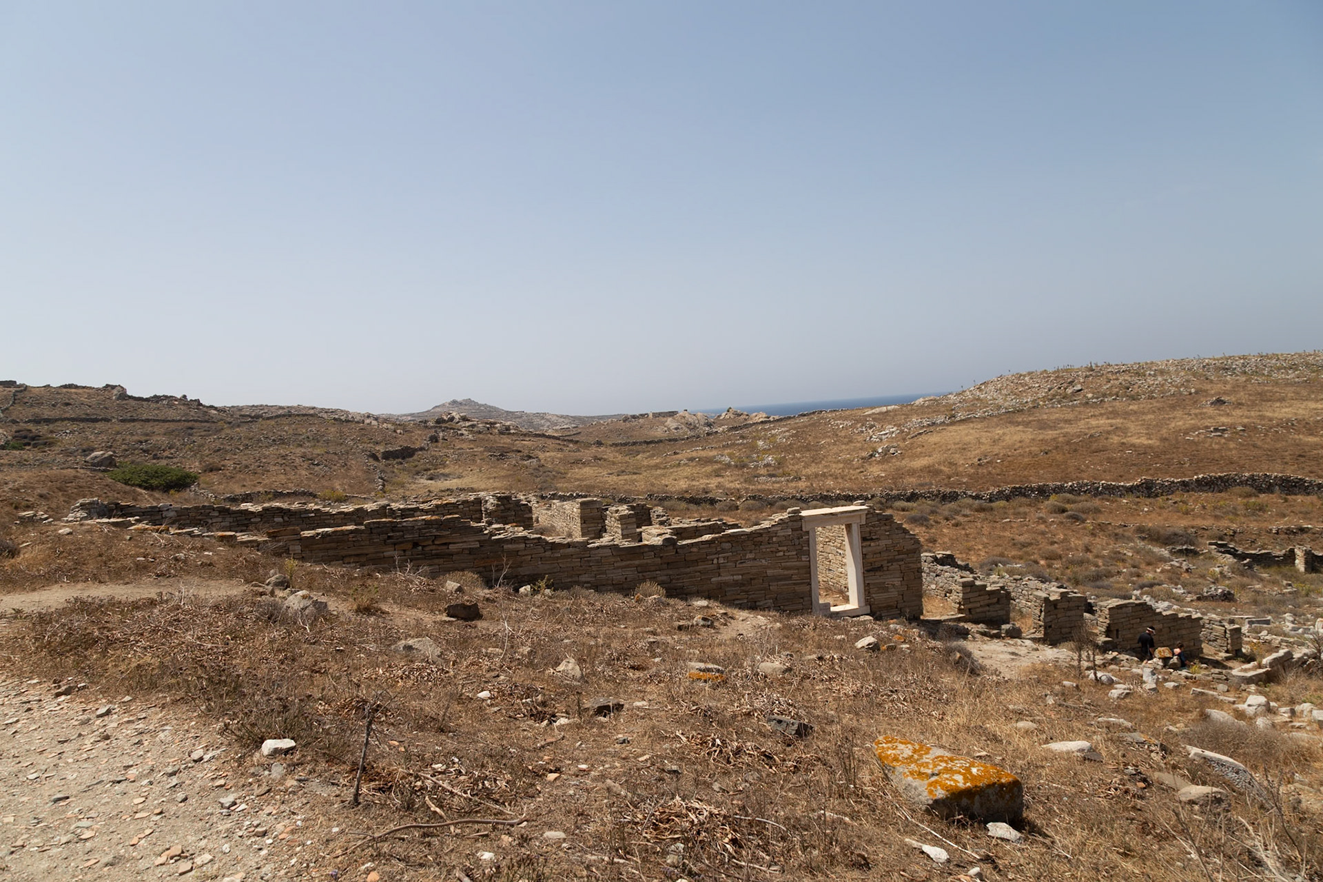 Delos, Greece - May 22nd 2018: Tourists explore the ancient ruins of Delos, a UNESCO World Heritage site, to learn about the island's rich history and mythology.