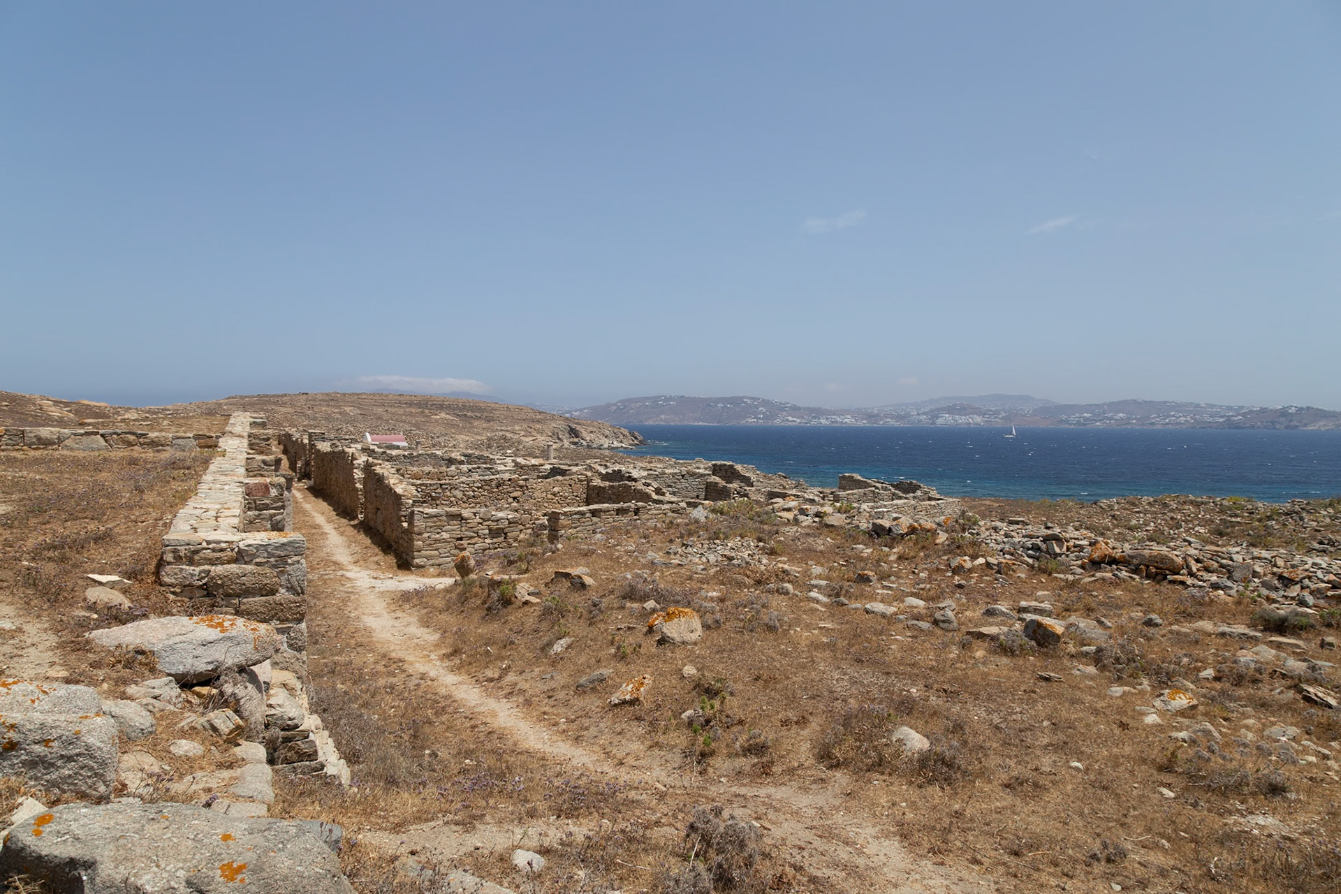 Delos, Greece - May 22nd 2018: Ancient ruins stand on Delos, a Greek island and archaeological site. The ruins offer a glimpse into the island's rich history.