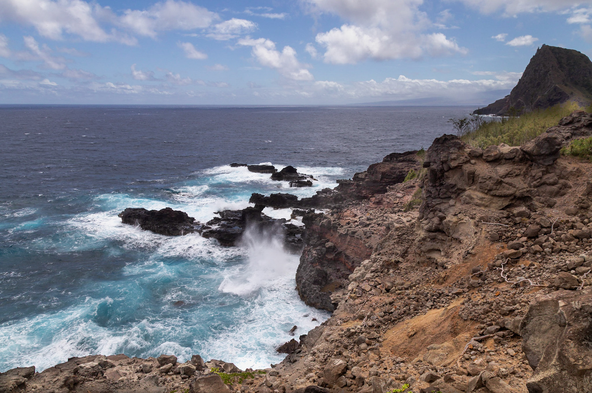 Maui, Hawaii, USA - April 9th 2022: Waves crash against the rocky coastline, showcasing the raw power and beauty of the Pacific Ocean.