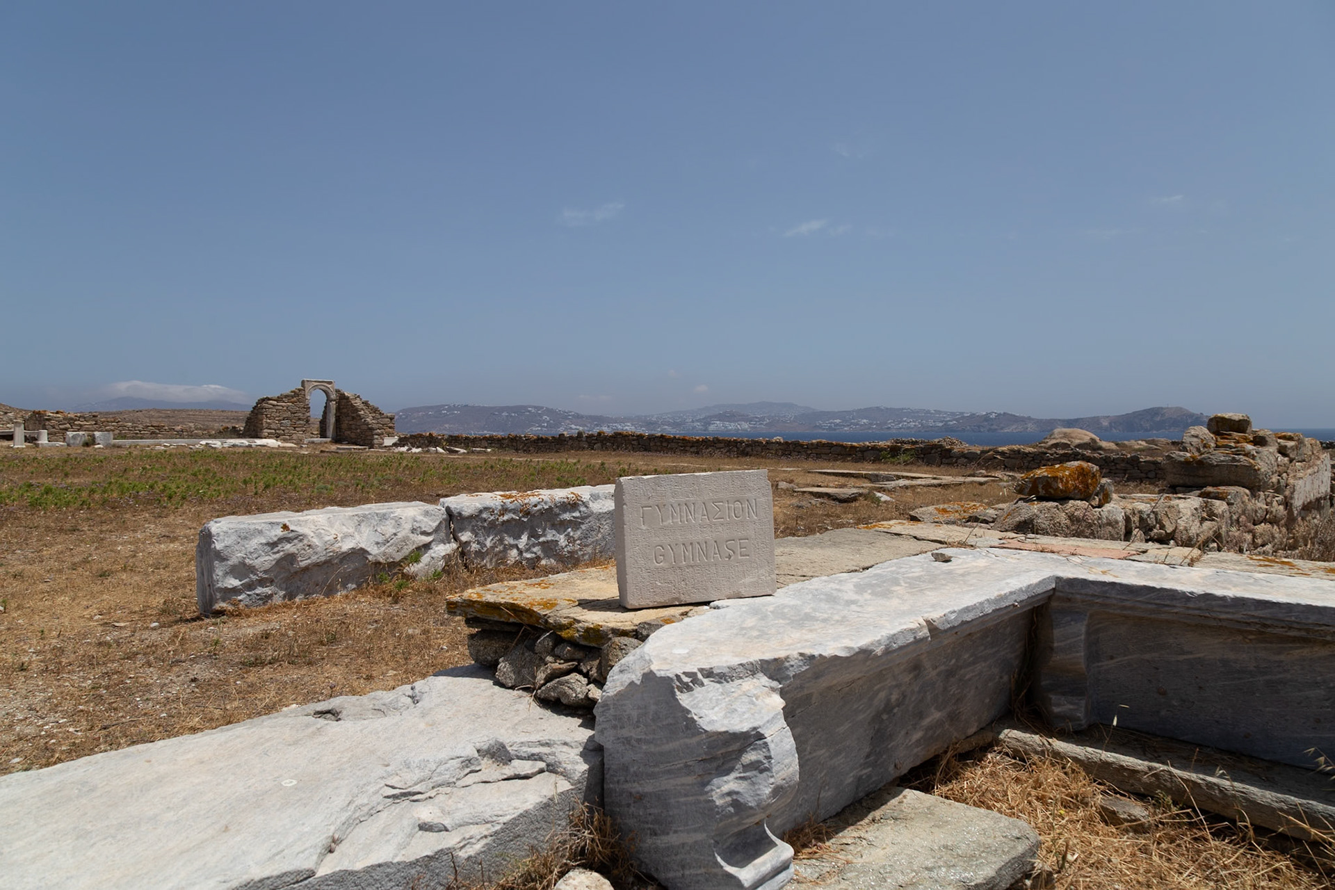 Delos, Greece - May 22nd 2018: Ruins of the Gymnasium, a place for athletic training and education in ancient Delos, stand as a testament to the island's rich history.