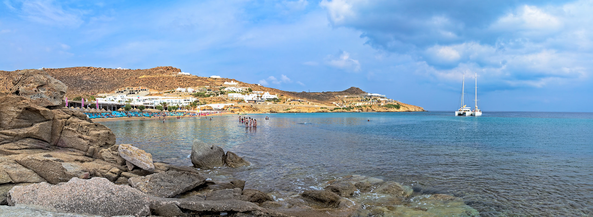 Paradise Beach, Mykonos, Greece - May 24th 2018: People enjoy the sun and sea at Paradise Beach, a popular tourist destination known for its lively atmosphere.