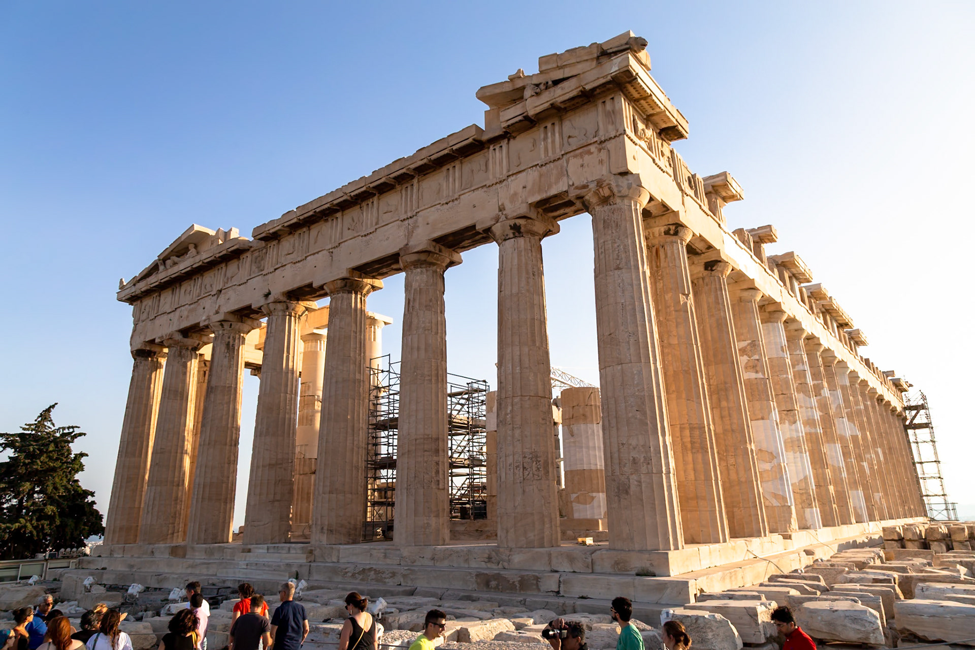 Acropolis, Athens, Greece - May 23rd 2018: Tourists visit the Parthenon, a temple dedicated to the goddess Athena, undergoing restoration work.