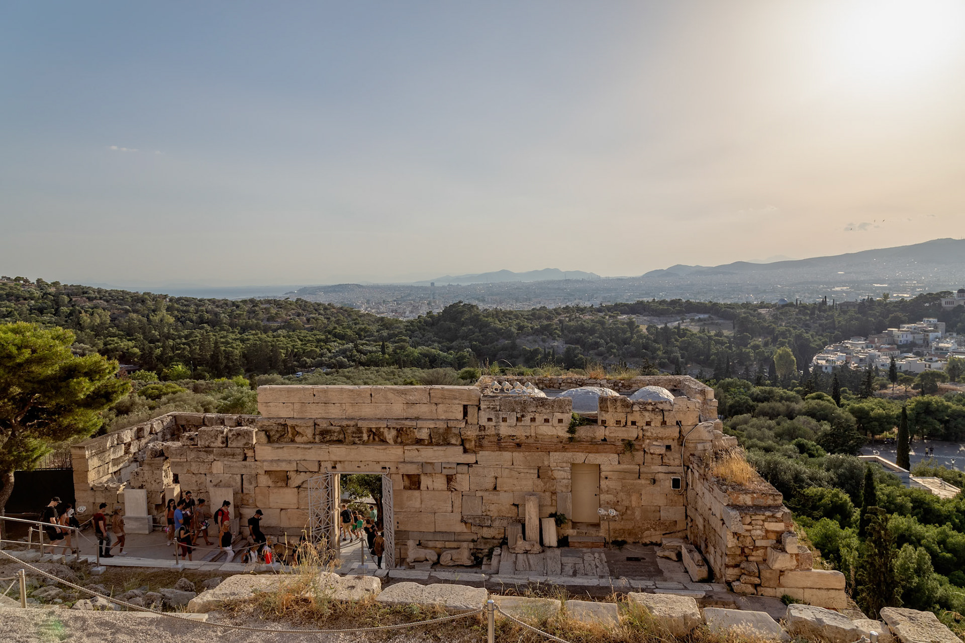 Acropolis, Athens, Greece - May 23rd 2018: Tourists explore the Propylaea, the monumental gateway to the Acropolis, to experience ancient Greek architecture.