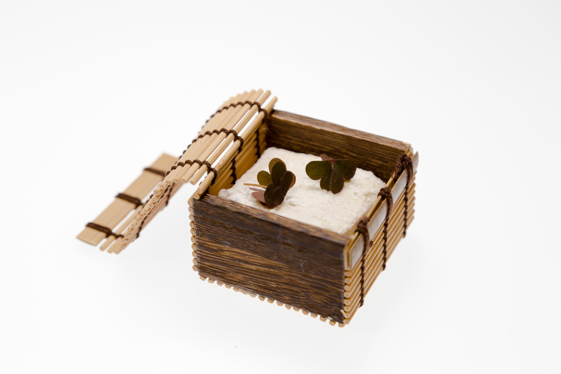 Fog Lark, Portland, Oregon - April 6th 2018: A small wooden box with a lid open, containing a white substance and two four-leaf clover decorations.