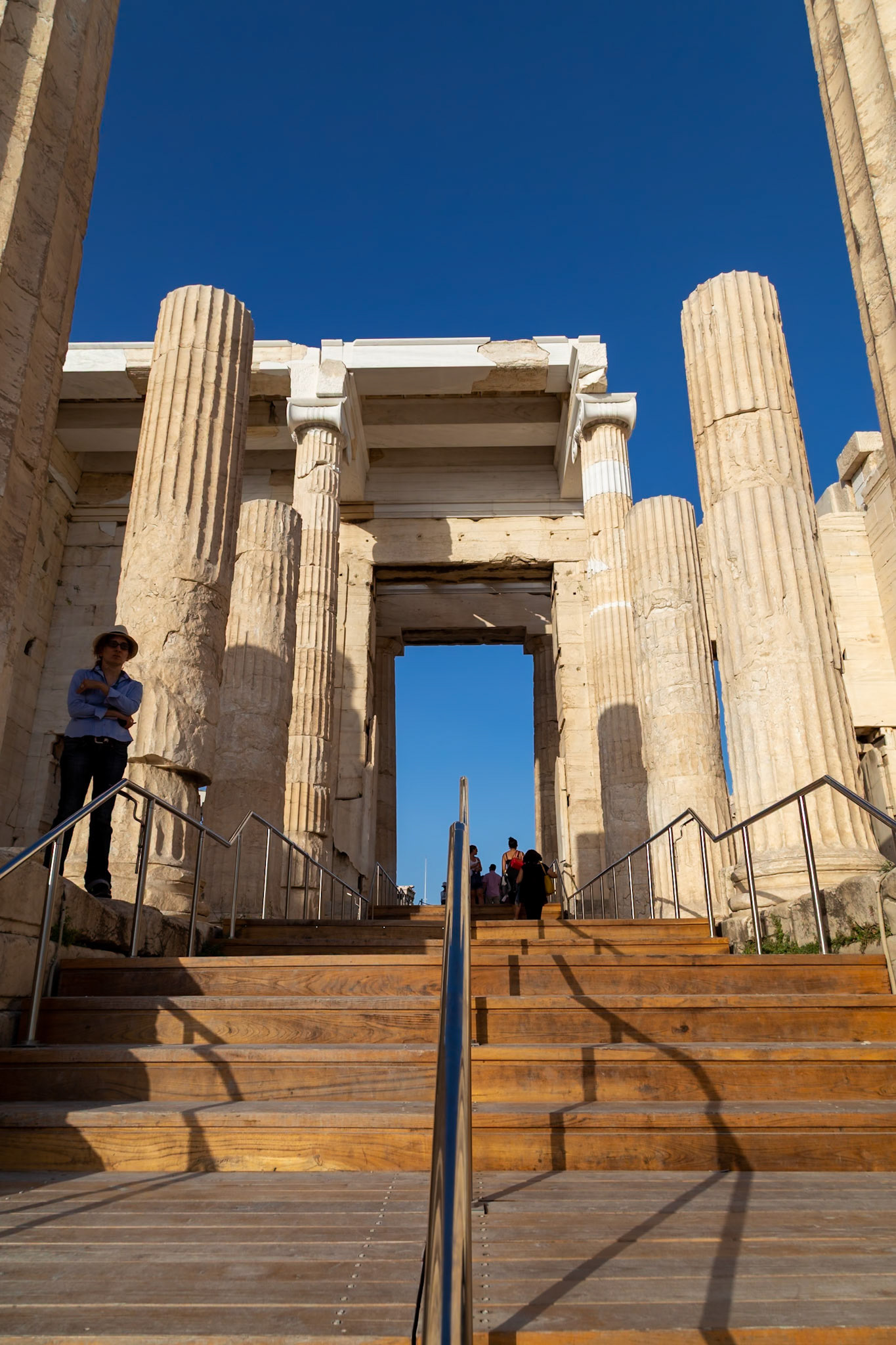 Acropolis, Athens, Greece - May 23rd 2018: Tourists ascend the steps to the Propylaea, the monumental gateway to the Acropolis, exploring ancient Greek architecture.