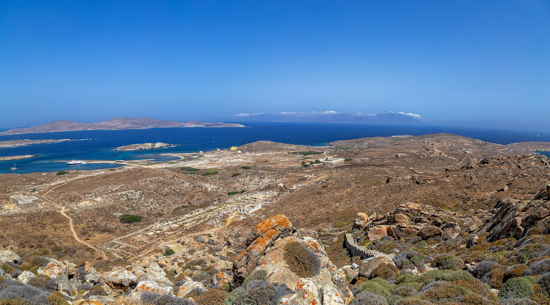 Delos, Greece - May 22nd 2018: A panoramic view of the island of Delos, showcasing its ancient ruins and the surrounding Aegean Sea, highlighting its historical significance.