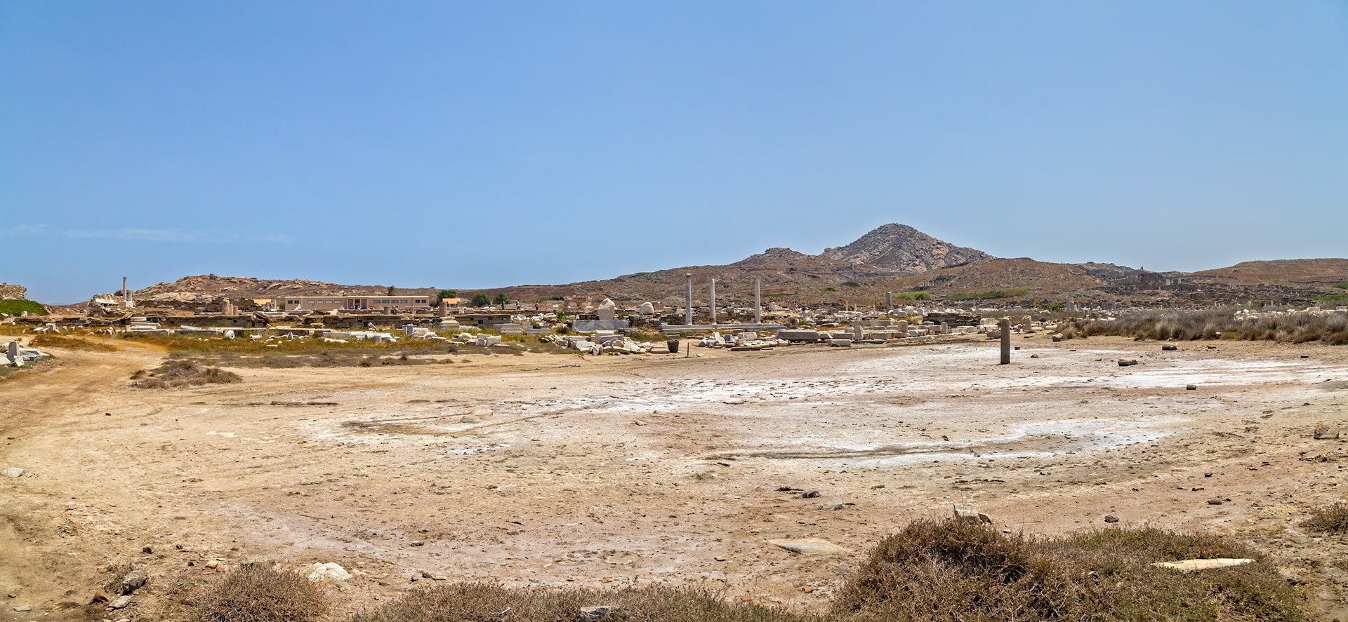 Delos, Greece - May 22nd 2018: Ruins of the ancient city of Delos, a UNESCO World Heritage site, are seen. The island was a major religious center in ancient Greece.