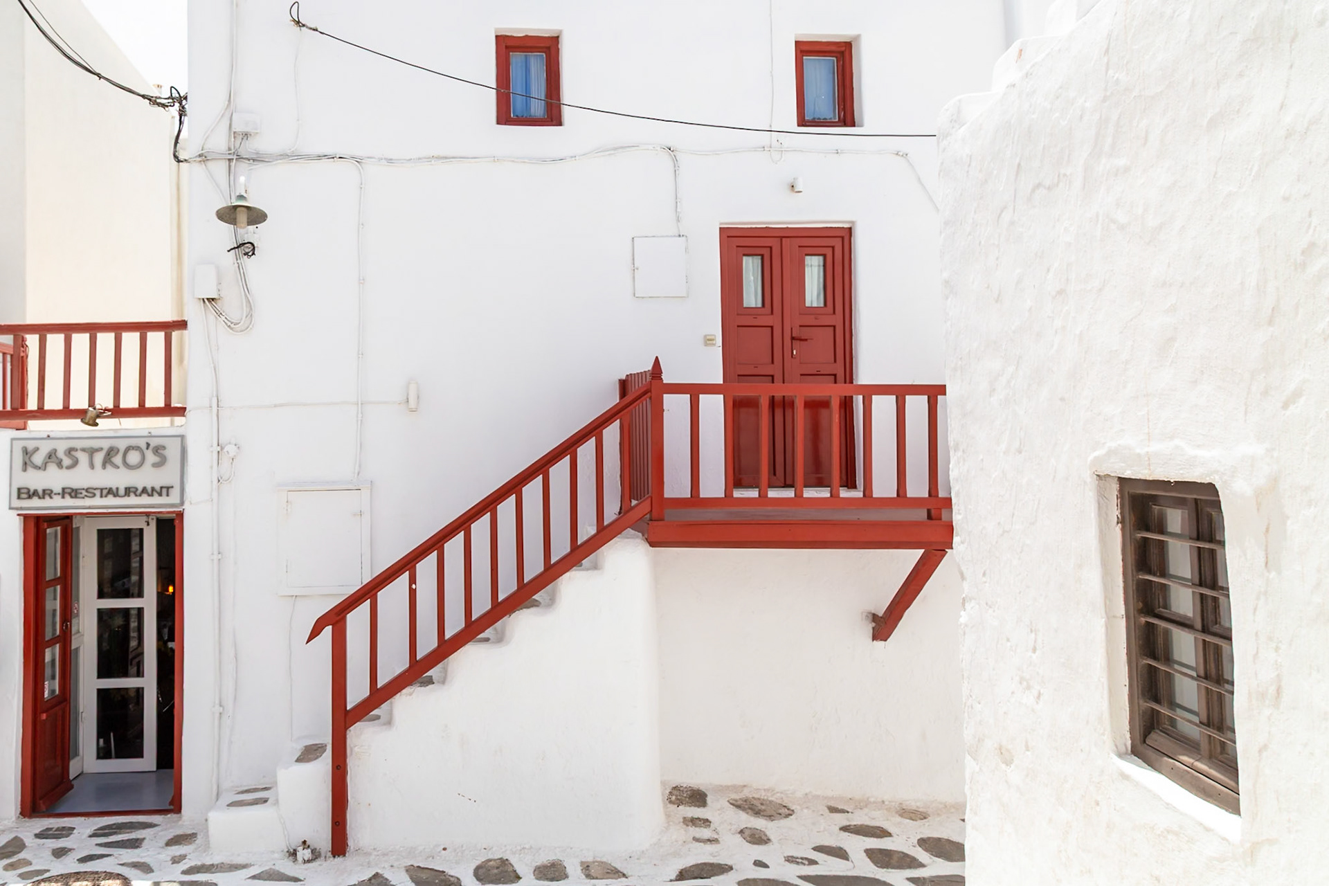 Mykonos, Greece - May 23rd 2018: Kastro's Bar-Restaurant is open for business, inviting guests to enjoy the local cuisine and atmosphere.