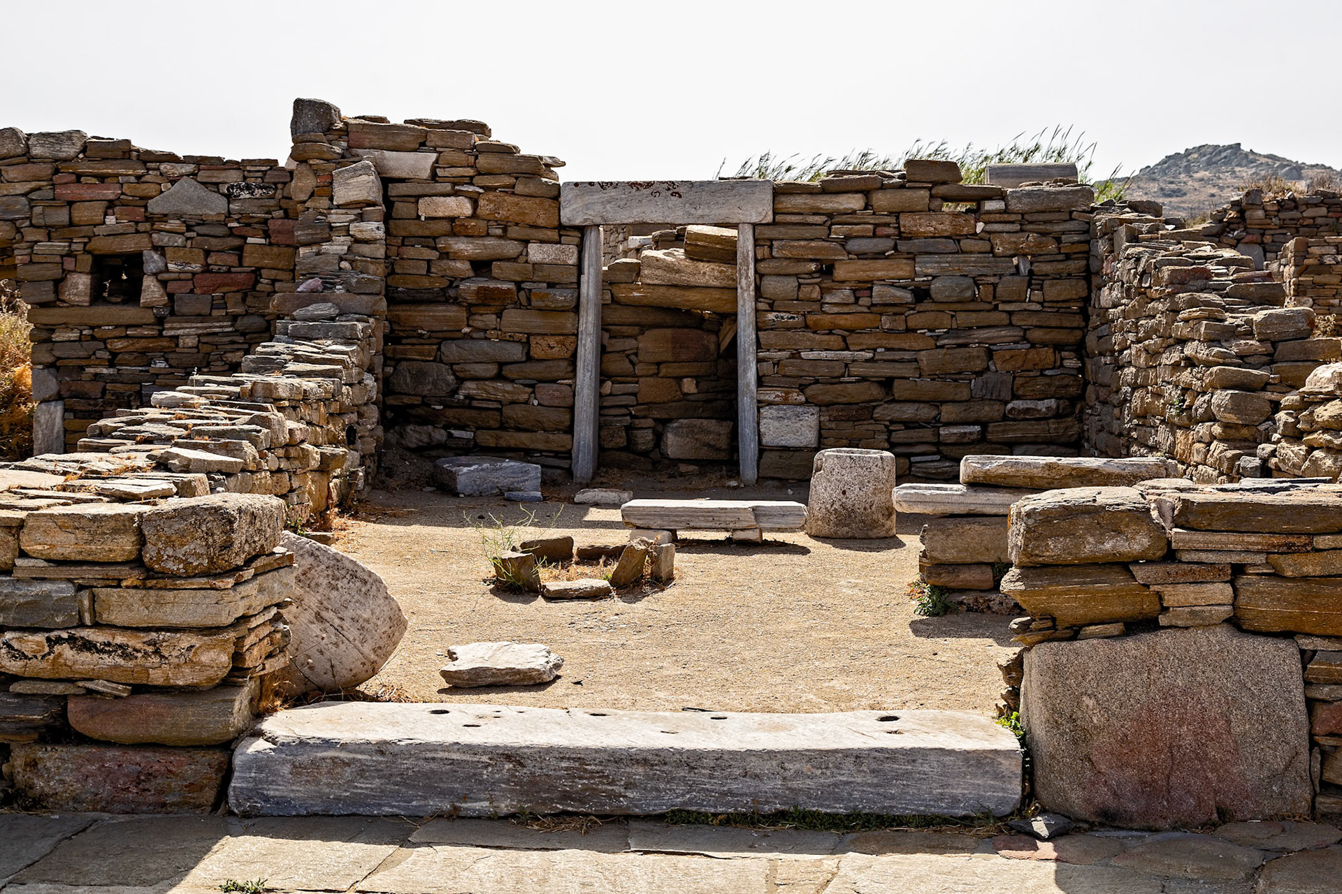 Delos, Greece - May 22nd 2018: Ruins of an ancient stone structure stand as a testament to the island's rich history and cultural significance.