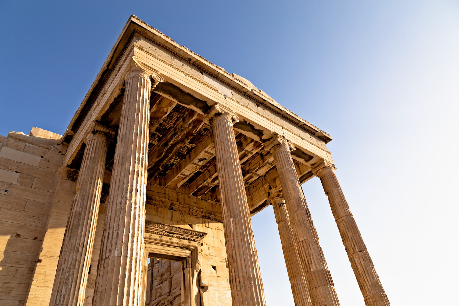 Acropolis, Athens, Greece - May 23rd 2018: A low angle shot of the Erechtheion, an ancient Greek temple on the north side of the Acropolis of Athens.