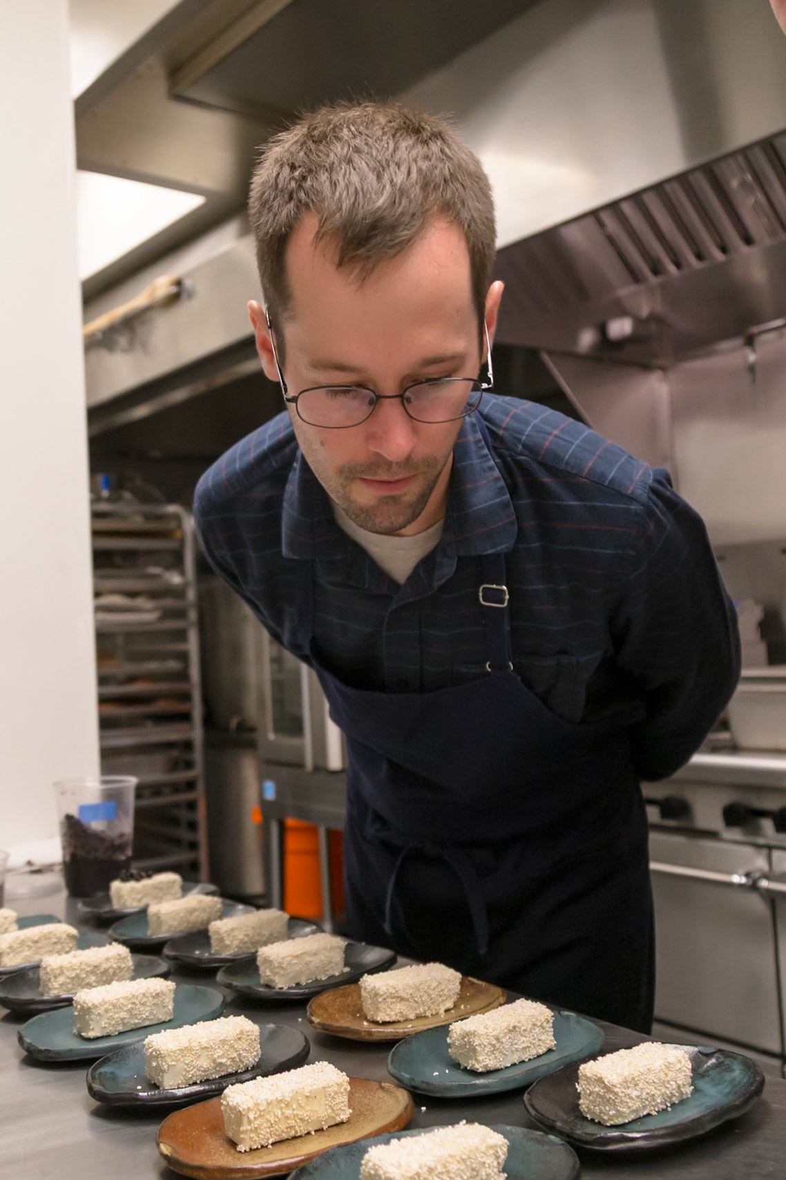 Fog Lark, Portland, Oregon - April 6th 2018: A chef meticulously plates desserts, ensuring each is perfect before service.