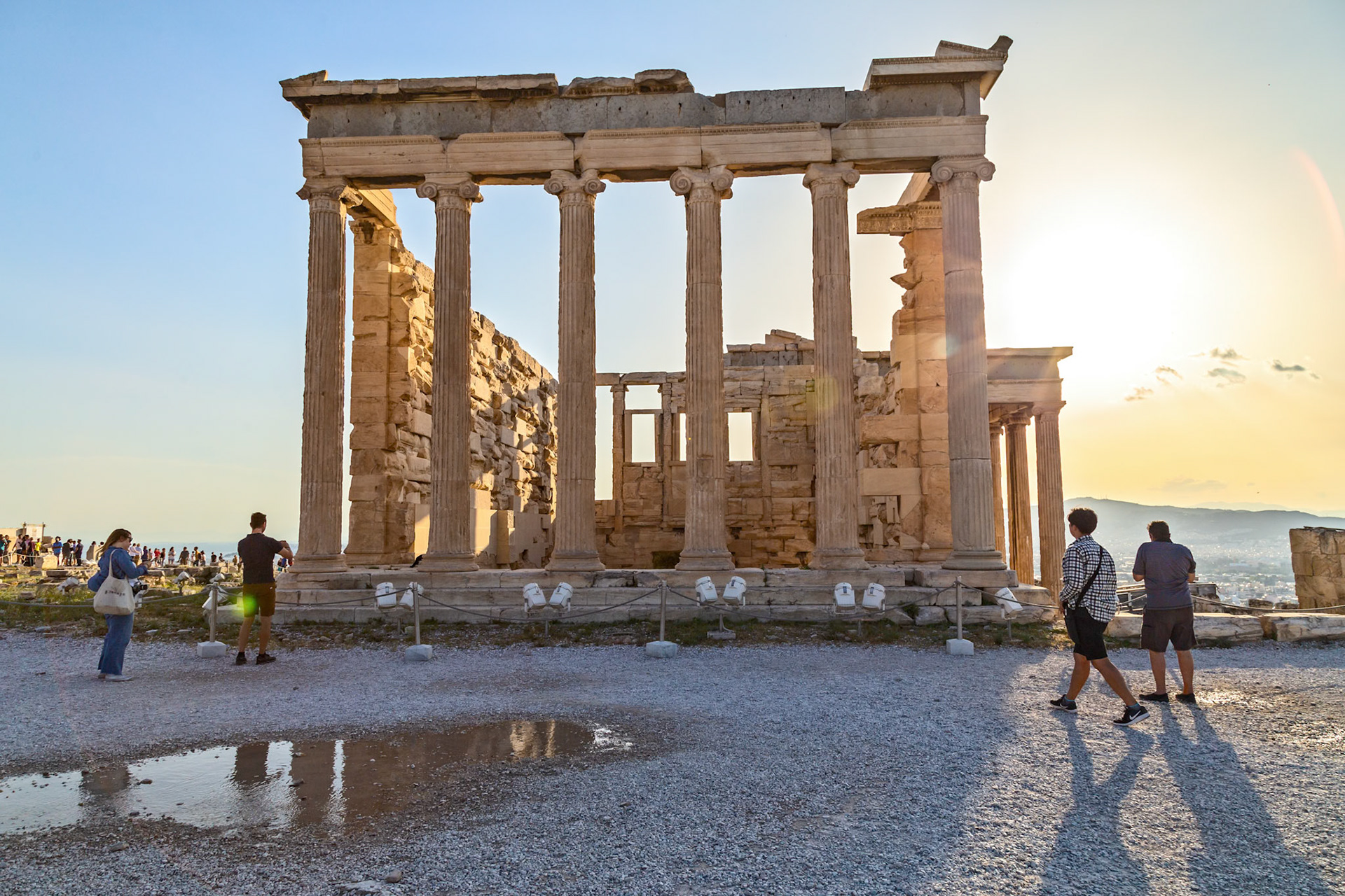 Acropolis, Athens, Greece - May 23rd 2018: Tourists visit the Erechtheion, an ancient Greek temple on the north side of the Acropolis, to learn about its history.